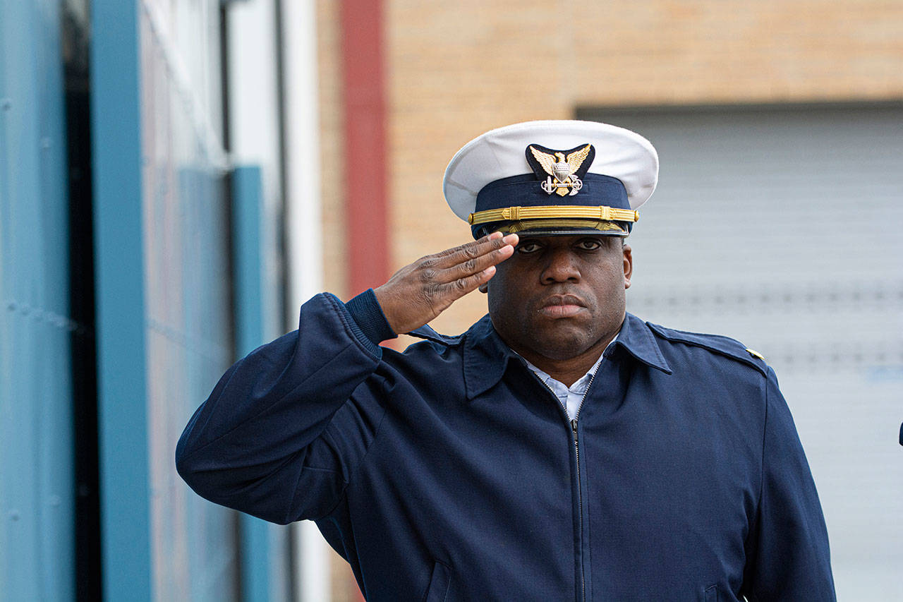 Lt. Cmdr. Harold Piper salutes during the national anthem at the Veterans Day ceremony at U.S. Coast Guard Air Station/Sector Field Office Port Angeles on Monday. (Jesse Major/Peninsula Daily News)