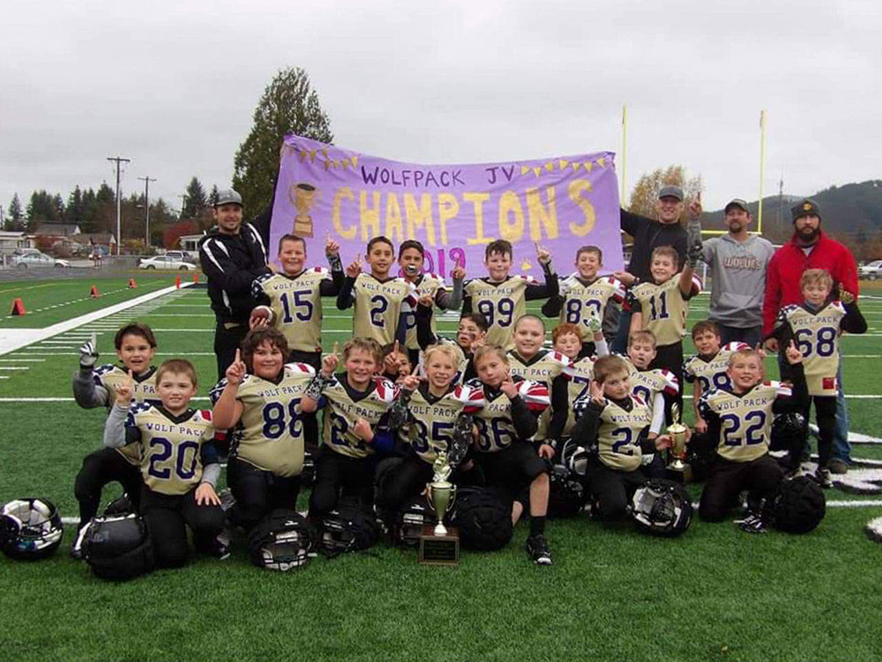 One proud (wolf)pack: The Sequim Wolf Pack junior varsity squad, a team of third- and fourth-graders, celebrates a 13-12 win against the PA Future Roughriders in Forks on Nov. 9. Sequim quarterback Kaden Miller threw two touchdown passes, both to Nolan Bacchus. Miller also ran in an extra-point-after-touchdown to give Sequim the decisive one-point win. Submitted photo