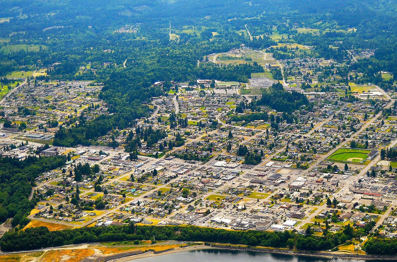 The growth in development across Clallam County in the past 25 years including Carlsborg (above), Sequim and Port Angeles (below), has led to an increase in “impermeable surface area” such as buildings, roads and other pavement that don’t allow water to soak back into the ground but instead turn into stormwater runoff, Clallam County hydrologist Carol Creasey says. Land development can increase the percentage of water from rain or snowfall that turns into stormwater, and assists pollutants and toxins to eventually wind up in Puget Sound, she said. Sequim Gazette file photos by Michael Dashiell