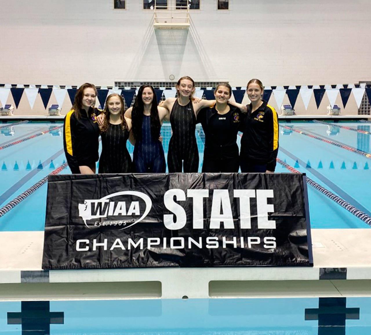 Sequim High’s girls swimming squad enjoys a weekend of top competition at the state 2A meet, held Nov. 15-16 in Federal Way. Sequim’s state 2A competitors include, from left, are Eislynn Flood, Natalie George, Lauren Sundin, Mia Coffman, Francesca Bargis and head coach Sarah Thorson. Submitted photo
