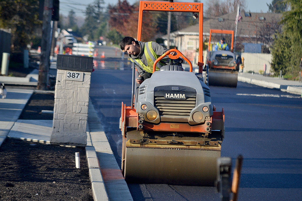 Zach Dulik with Lakeside Industries smooths out a portion of Fir Street on Nov. 22 as the initial overlay goes down in front of Helen Haller Elementary. Sequim Gazette photo by Matthew Nash