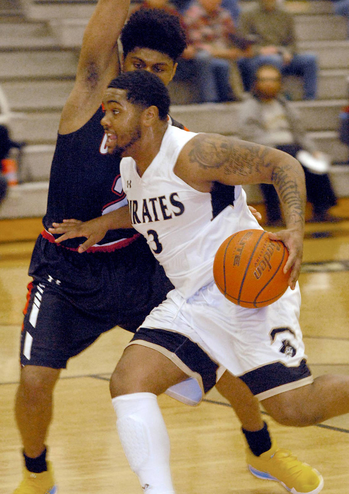 Peninsula’s Davien Harris-Williams drives past the defense of Olympic’s Will Johnson in the opening minutes of a conference match-up last season. Harris-Williams averaged 16.8 points per game and returns to lead the Pirates in 2019-2020. File photo by Keith Thorpe/Olympic Peninsula News Group