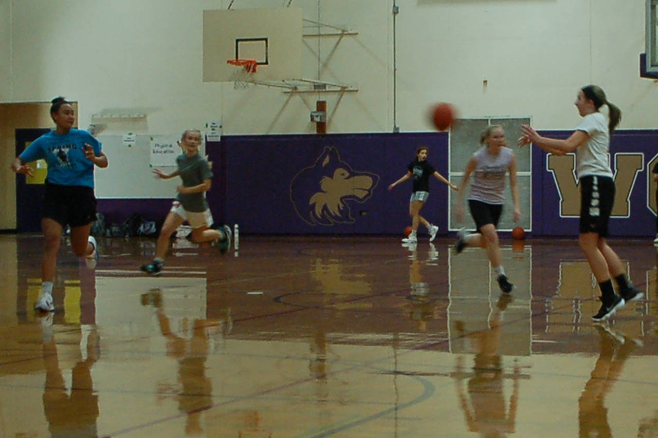 The Sequim Wolves girls basketball varsity players, including pictured from left Jayla Julmist, Hannah Wagner, Jessica Dietzman, Melissa Porter and Kali Wiker, run drills during a pre-season practice on Nov. 21. Sequim Gazette photo by Conor Dowley