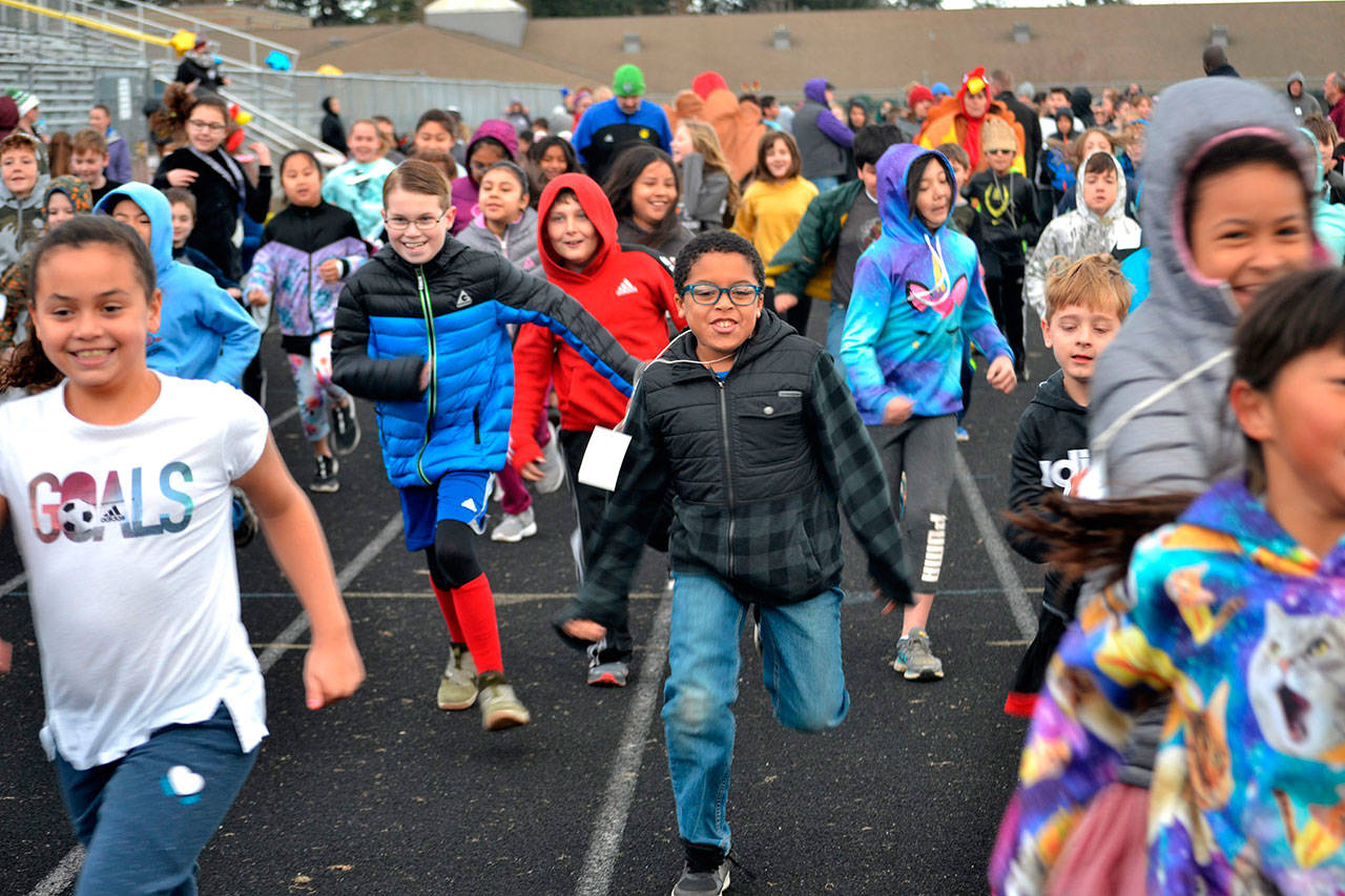 Tayshaun Williams runs with a pack of fellow fourth graders during Helen Haller Elementary’s Turkey Trot on Nov. 27. More than 500 students participated in the event to raise funds for Six Books for Summer. Sequim Gazette photo by Matthew Nash