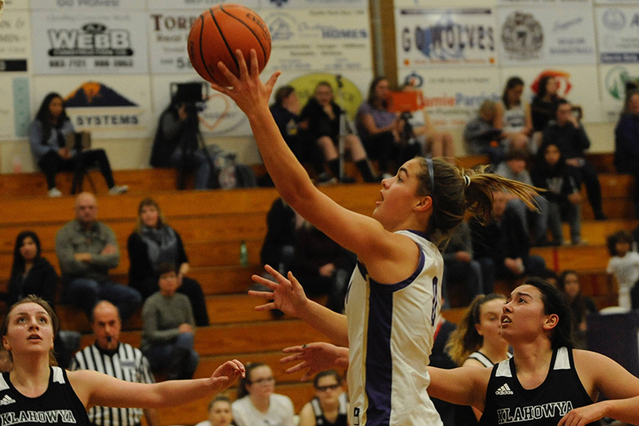 Sequim Wolves forward Hope Glasser, center, goes up for a layup against the Klahowya Eagles during the Wolves’ 73-17 win over the Eagles on Dec. 2. Glasser scored 11 points on the night, and was a key part in keeping the Eagles’ offense quiet on the night. Sequim Gazette photo by Conor Dowley