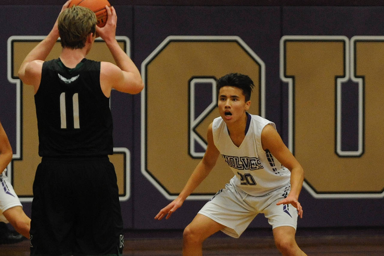 Junior guard Riley Chen, right, guards Klahowya Eagles guard Preston Roberts during the Sequim Wolves 45-37 comeback win over the Eagles on Dec. 2. Chen lead the team in scoring with 14 points on the night, including a trio of key three pointers in the second half that helped the Wolves close the gap as they came back from a 23-16 halftime deficit. Sequim Gazette photo by Conor Dowley