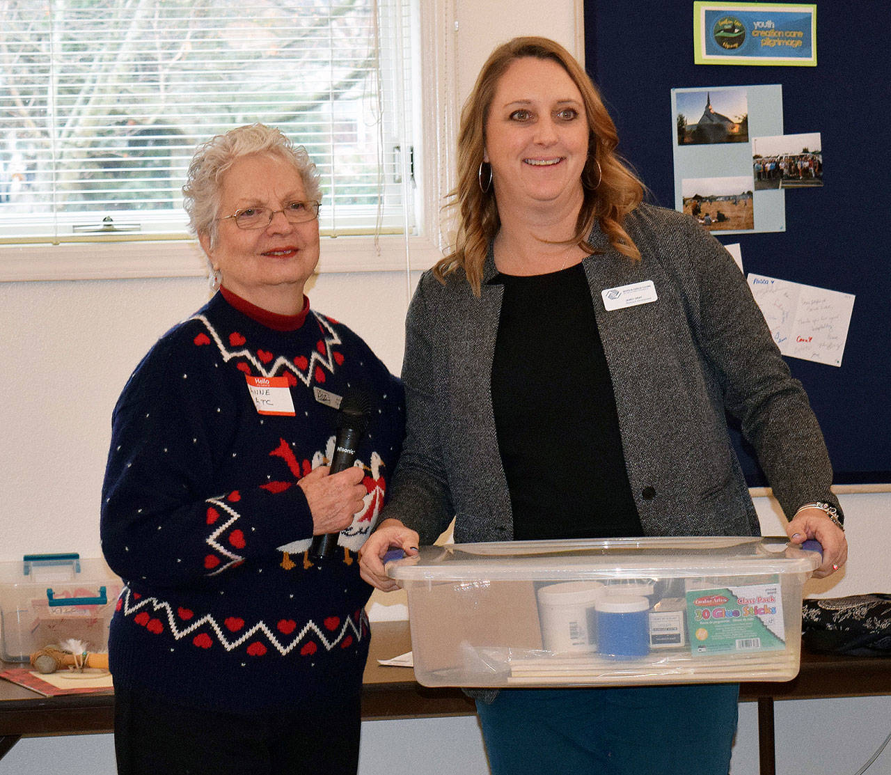 At left, Anne Grasteit, Olympic Peninsula Art Association President, presents a donation to Janet Gray of the Boys & Girls Clubs of the Olympic Peninsula. Submitted photo