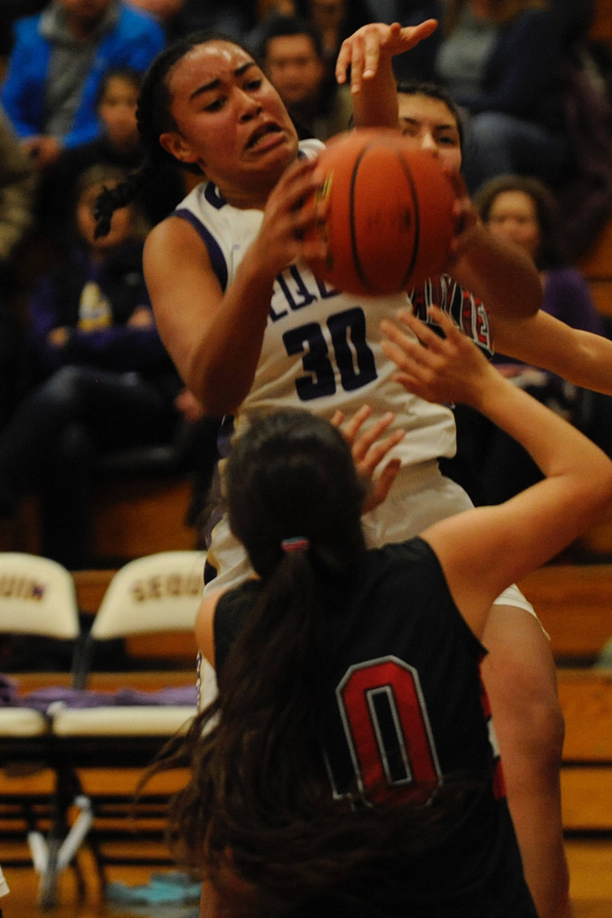 Jaylah Julmist (30) gets fouled while getting an offensive rebound in the second quarter against Neah Bay during the Sequim Wolves’ 86-63 win on Dec. 4. Sequim Gazette photo by Conor Dowley