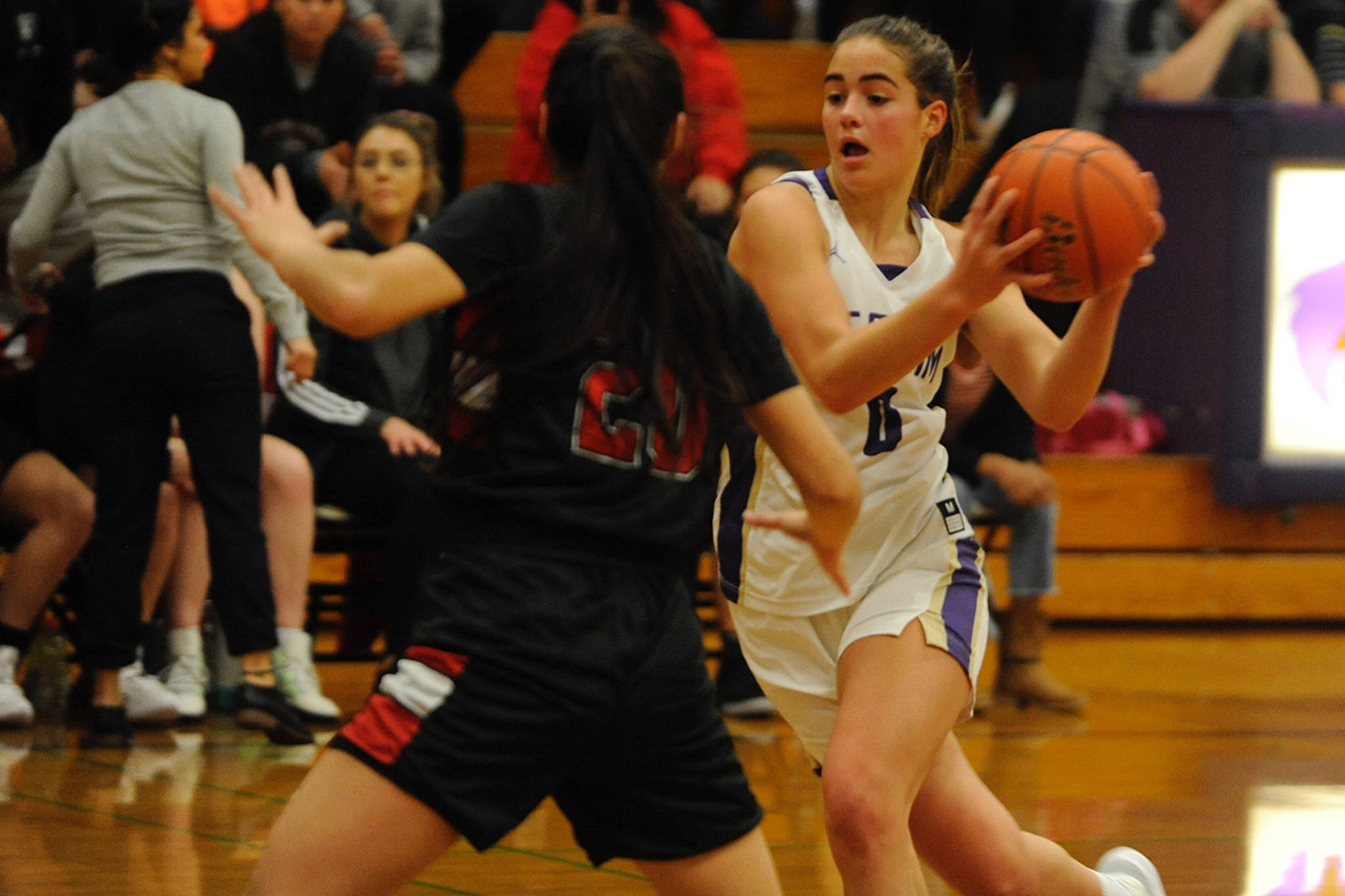 Hope Glasser (0) drives into the lane against Neah Bay forward Cei’ J Gagnon during the first quarter of the Sequim Wolves’ 86-63 win on Dec. 4. Sequim Gazette photo by Conor Dowley