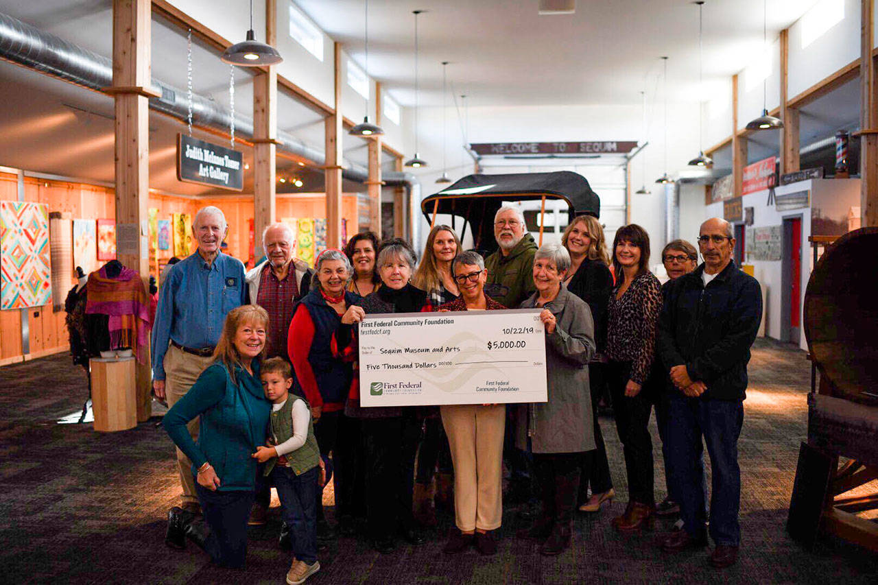 Pictured are, from left, Bob Clark, Marlin Holden, museum treasurer Ann Jagger, former museum director Katherine Vollenweider, museum secretary Bud Knapp, Sequim market area manager Ashley Slezak, First Federal regional manager Christy Rookard, museum bookkeeper Nancy Goldstein and volunteer John Majors, with (front row, from left) Trish Bekkevar (and grandson), Bev Majors, museum director Judith Reandeau Stipe, First Federal director Jan Simon and museum board president Hazel Ault. Submitted photo
