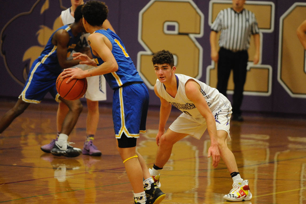 Dallin Despain (0) guards Bremerton Knights guard D’Angelo Moore (1) during the first quarter of the Sequim Wolves’ 77-62 loss to the Knights on Dec. 17. Sequim Gazette photo by Conor Dowley