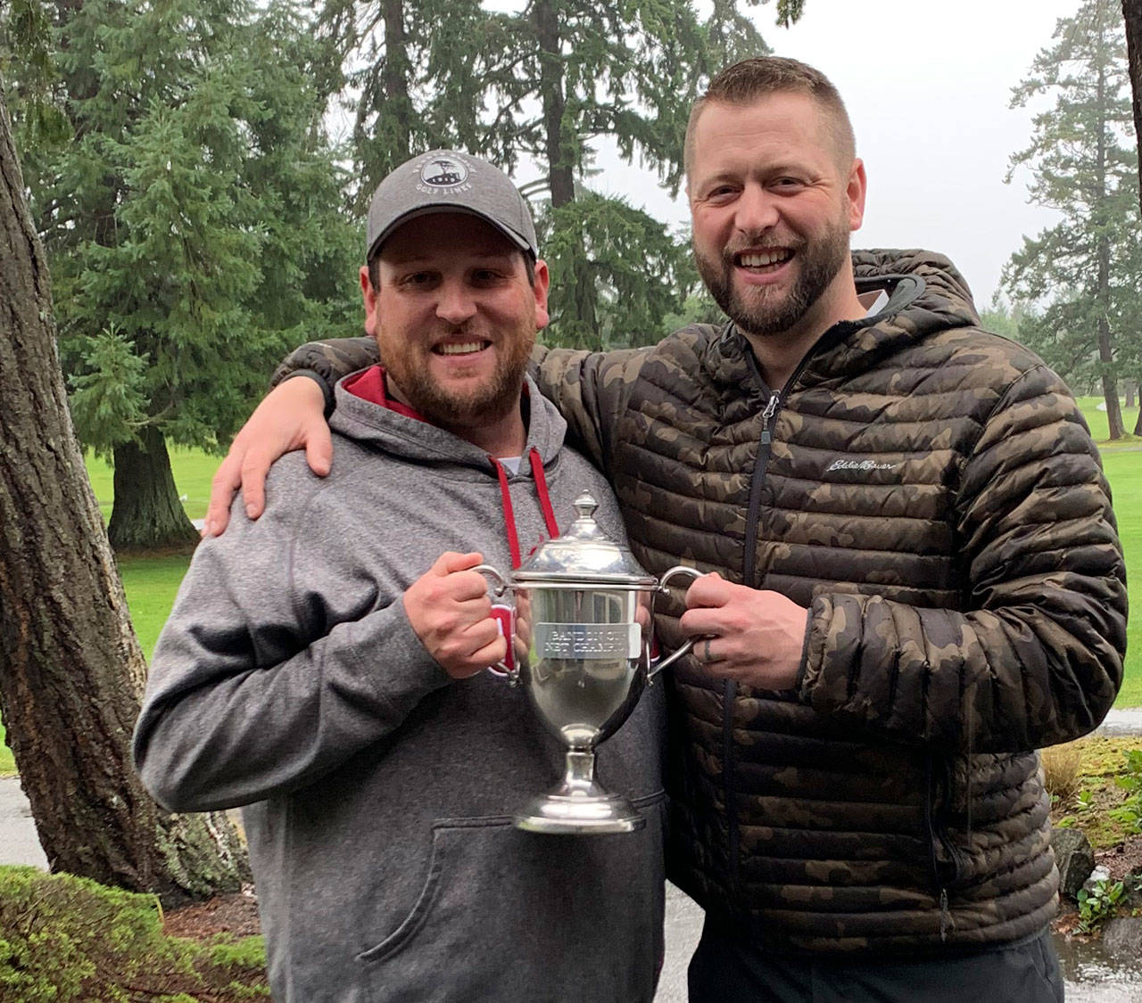 Kyler McCaslin, left, and Chad Wagner, who took low net and low gross honors respectively, helped lead Team Wagner to a win in the Battle at Bandon competition earlier this month. Submitted photo