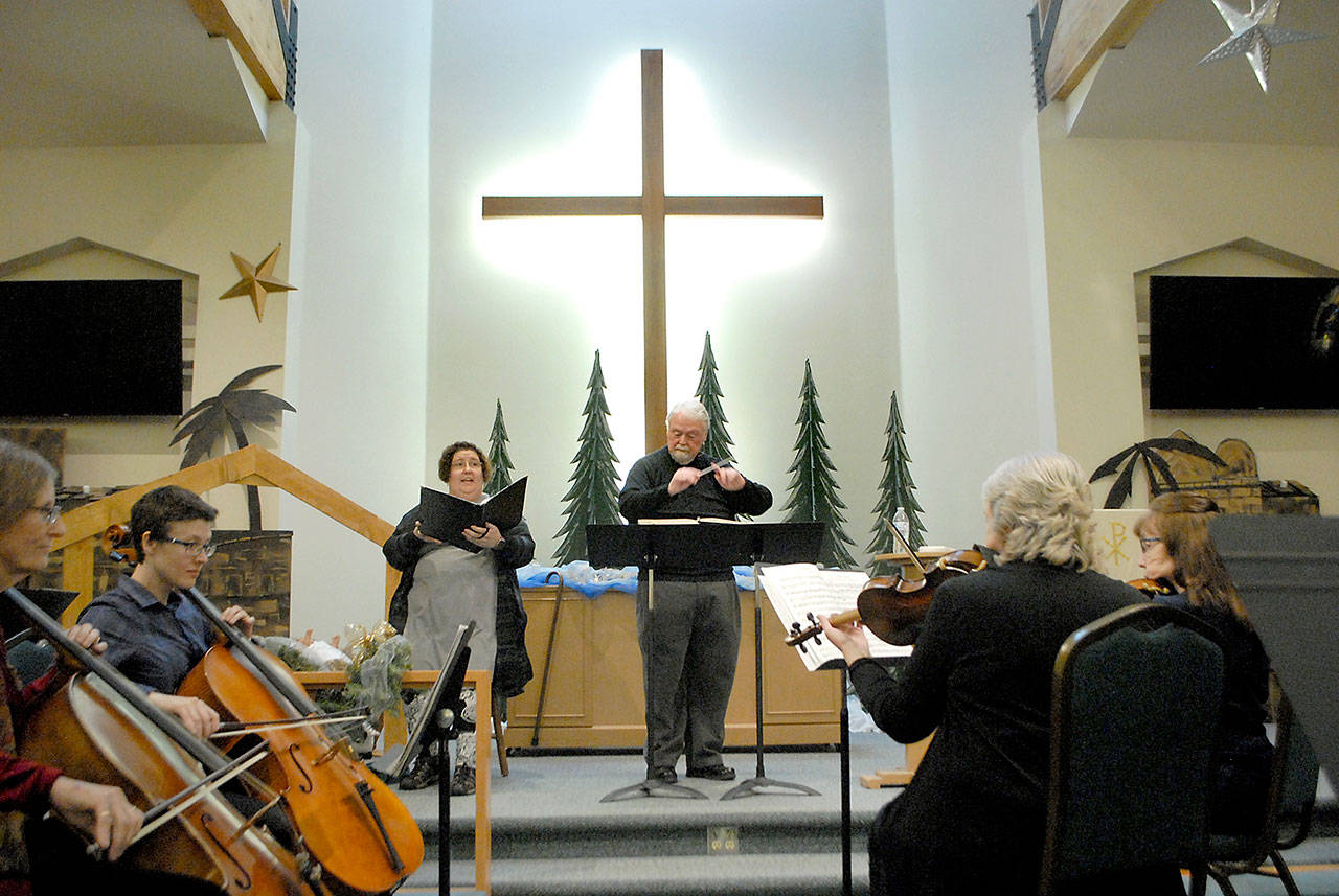 Soloist Vicki Helwick sings under the direction of conductor Jerome L. Wright during the Dec. 28, 20th-annual sing-along performance of Handel’s “Messiah” at Trinity United Methodist Church in Sequim. The free performace featured a variety of instrumentalists, guest soloists and participation from members of the audience. Photo by Keith Thorpe/Olympic Peninsula News Group