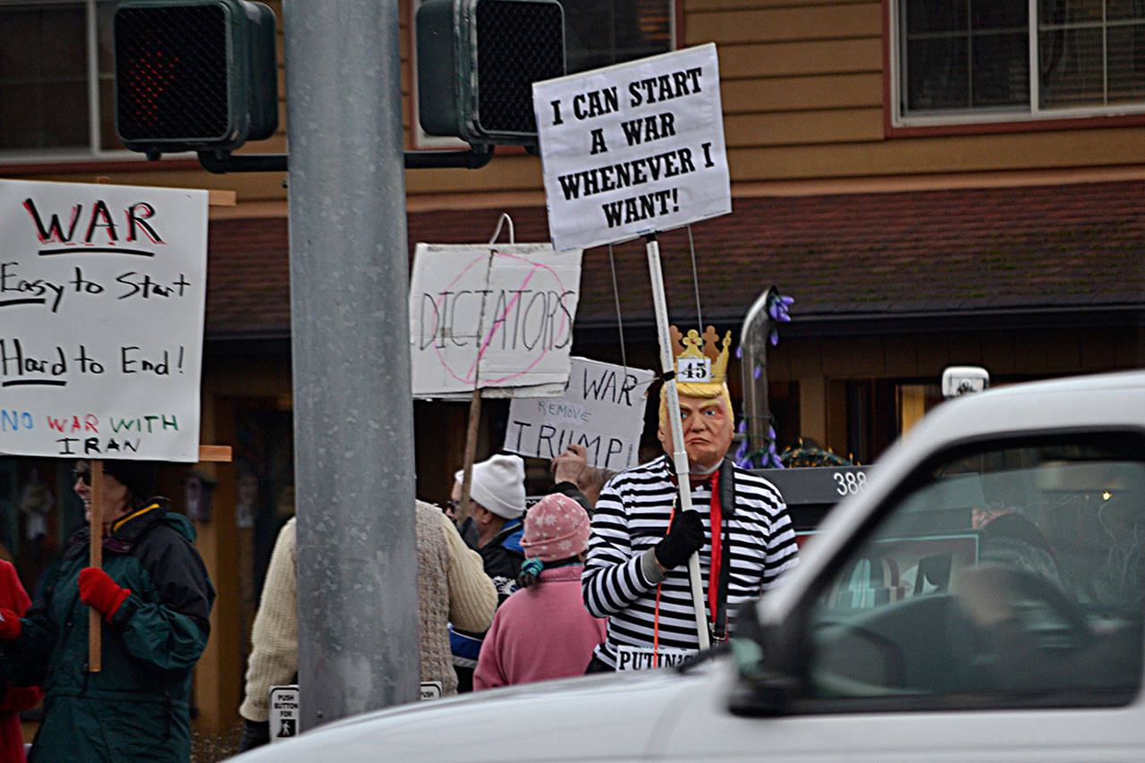 Lowell Rathbun, a group member of Indivisible Sequim and an executive board member of the Clallam County Democrats, stands dressed as President Donald Trump in opposition of a potential escalation of war with Iran over recent conflicts there.                                Sequim Gazette photos by Matthew Nash
