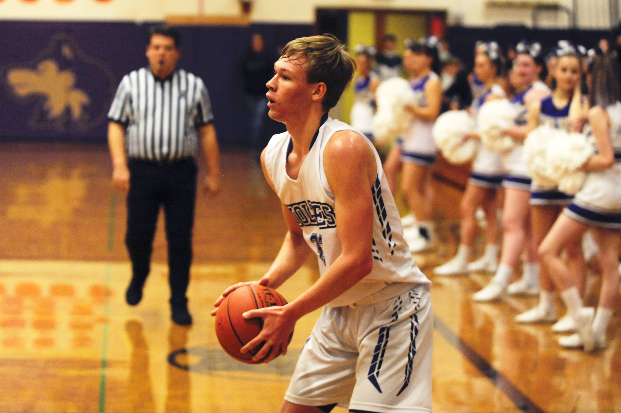 Sequim Wolves forward Stew Duncan sets up for a 3-point shot in the first quarter of the Wolves’ 51-49 win over the Olympic Trojans on Jan. 10. Duncan had a season-high 14 points on the night, and added eight rebounds, one block and one steal. Sequim Gazette photo by Conor Dowley