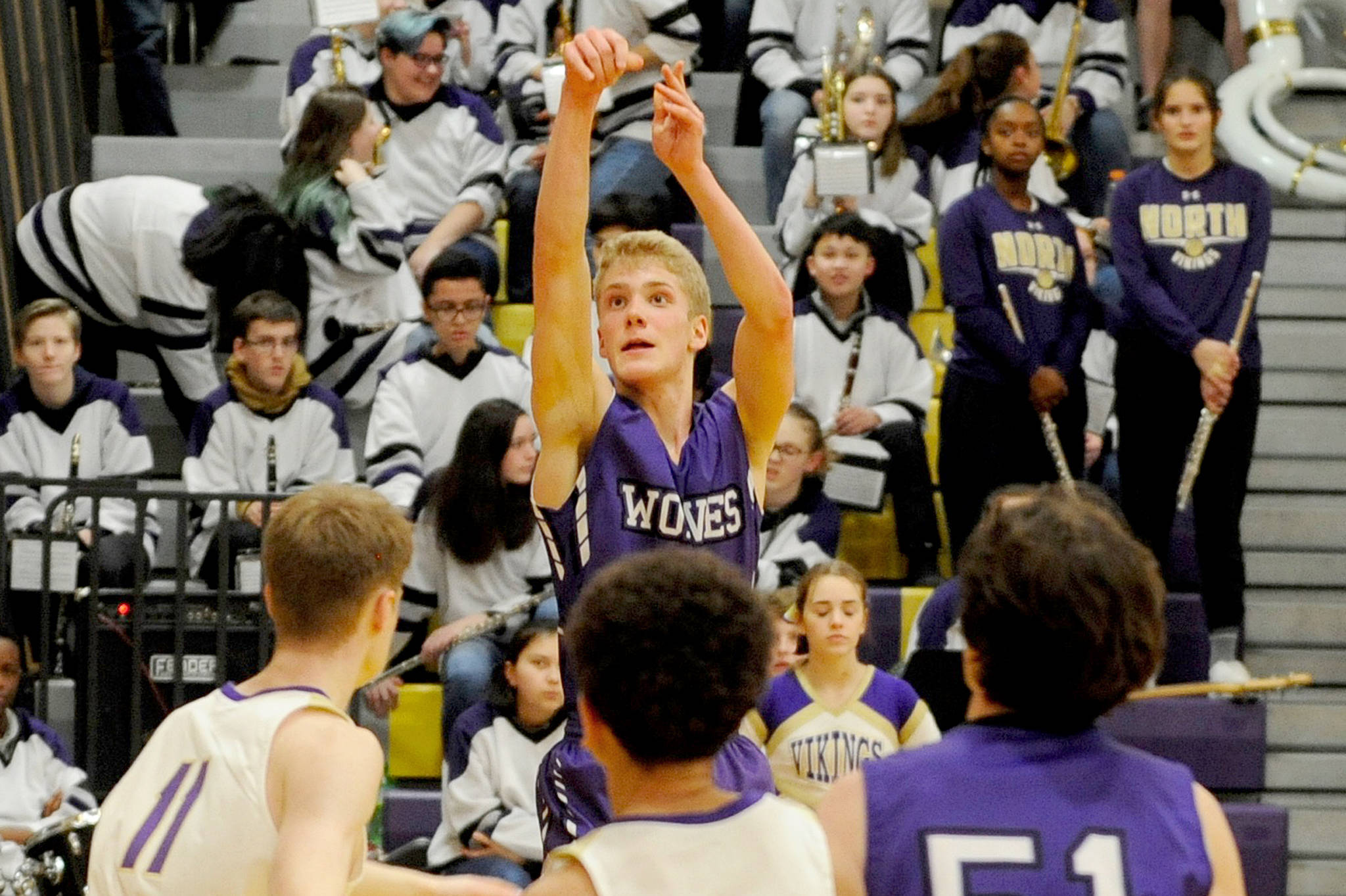 Sequim Wolves guard Erik Christiansen rises up for a 3-point shot in the second quarter of the Wolves’ 74-54 loss to the North Kitsap Vikings on Jan. 7. Christiansen lead the Wolves in scoring with 16 points on 6-of-14 shooting, including making two of six shots from 3-point range. Sequim Gazette photo by Conor Dowley