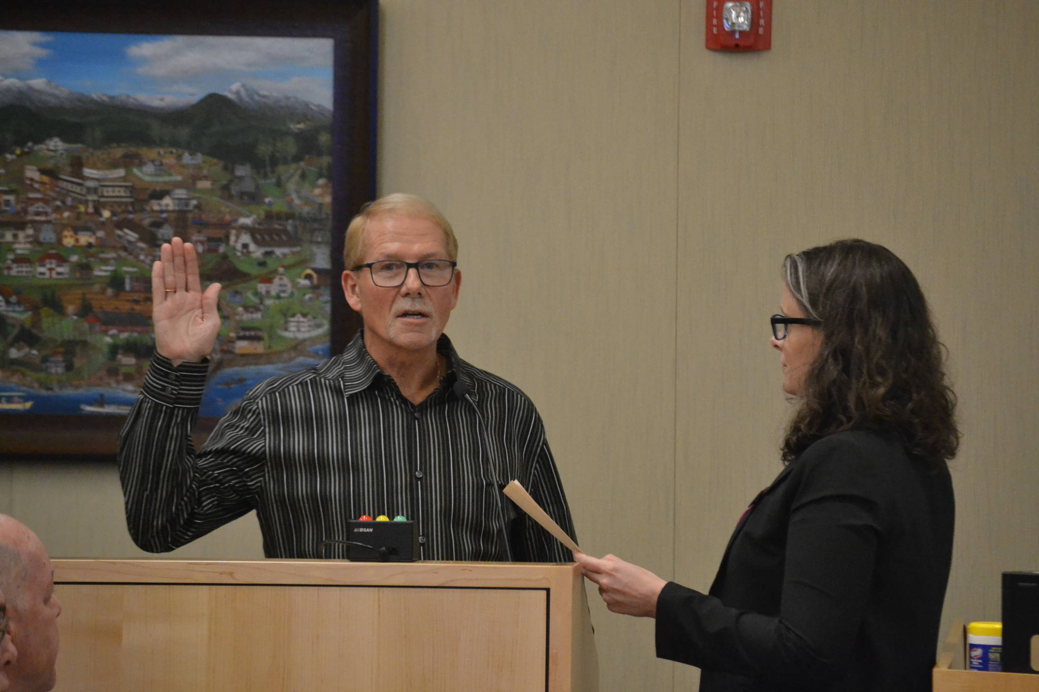 William Armacost is sworn into office on Jan. 13 by Sequim City Clerk Sara McMillon. He was also elected mayor by fellow city councilors. Sequim Gazette photo by Matthew Nash