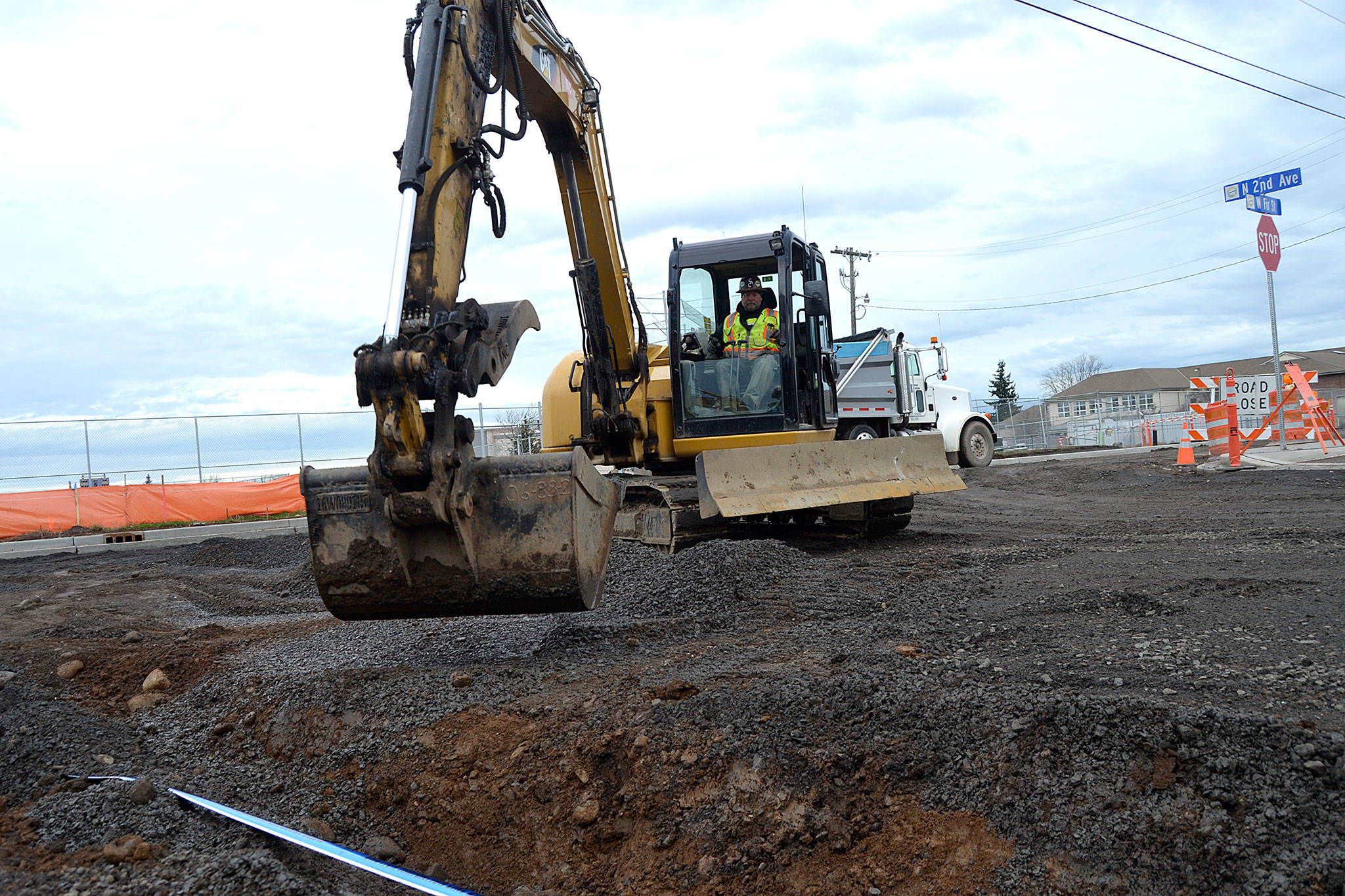 Work continued on Monday along West Fir Street after snow delayed Interwest Construction for a week. Here, crewmen cover irrigation pipeline at the Second Avenue and Fir Street intersection. Sequim Gazette photo by Matthew Nash