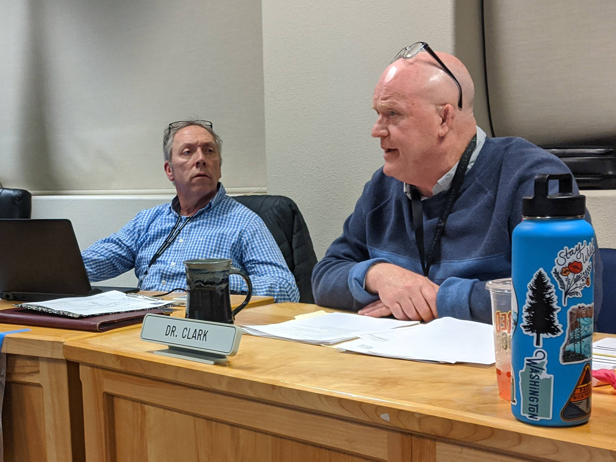 Sequim School District superintendent Rob Clark, right, discusses terms of his contract extension with the school board while board president Brandino Gibson listens on during the Jan. 21 school board meeting. Sequim Gazette photo by Conor Dowley