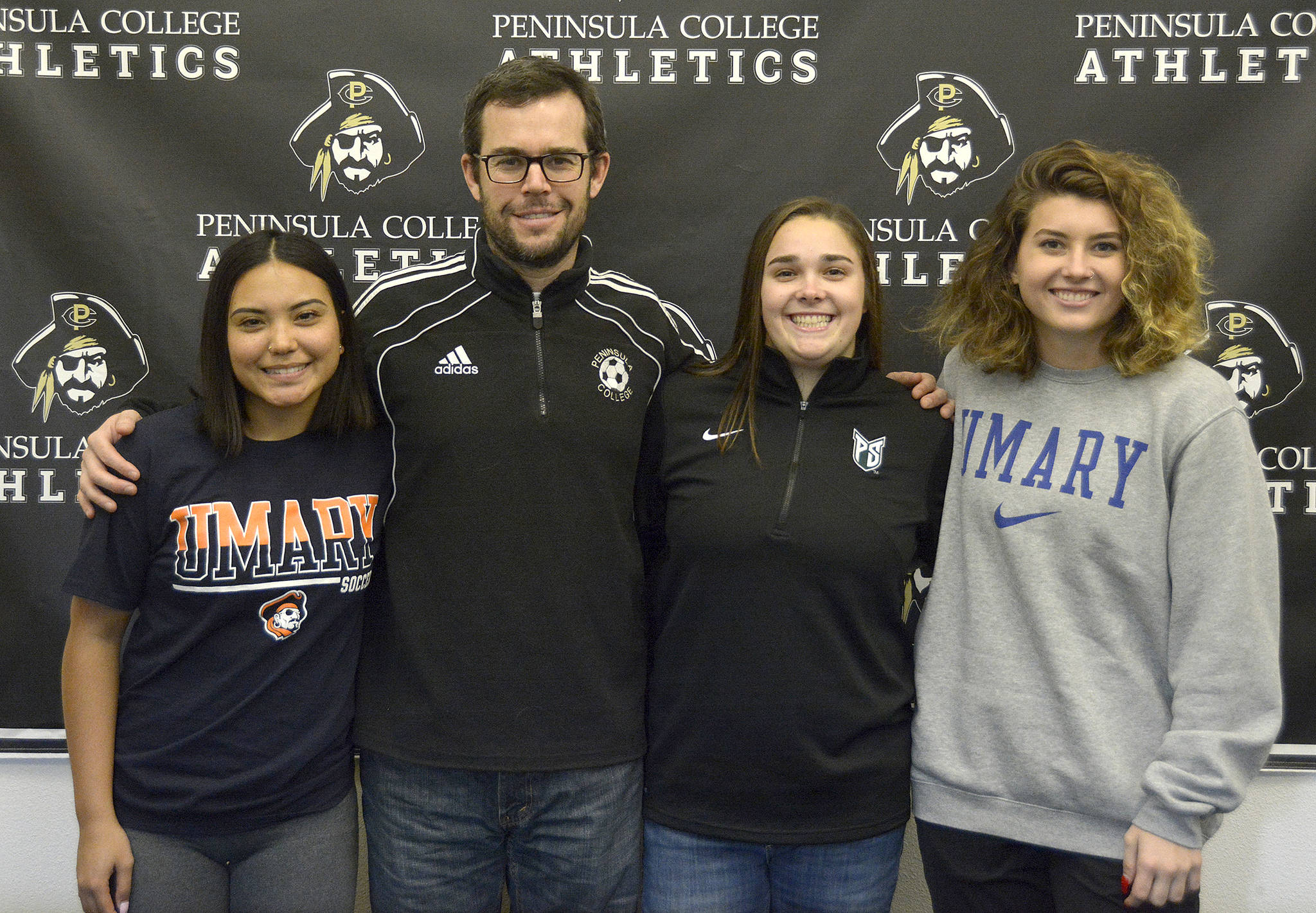 Peninsula College women’s soccer players (from left) Kayla Alcott, Sam Oliveira and Halle Nottage were joined by head coach Kanyon Anderson at a signing ceremony on Jan. 24. The three players will move on to play at four-year schools next fall. Submitted photo