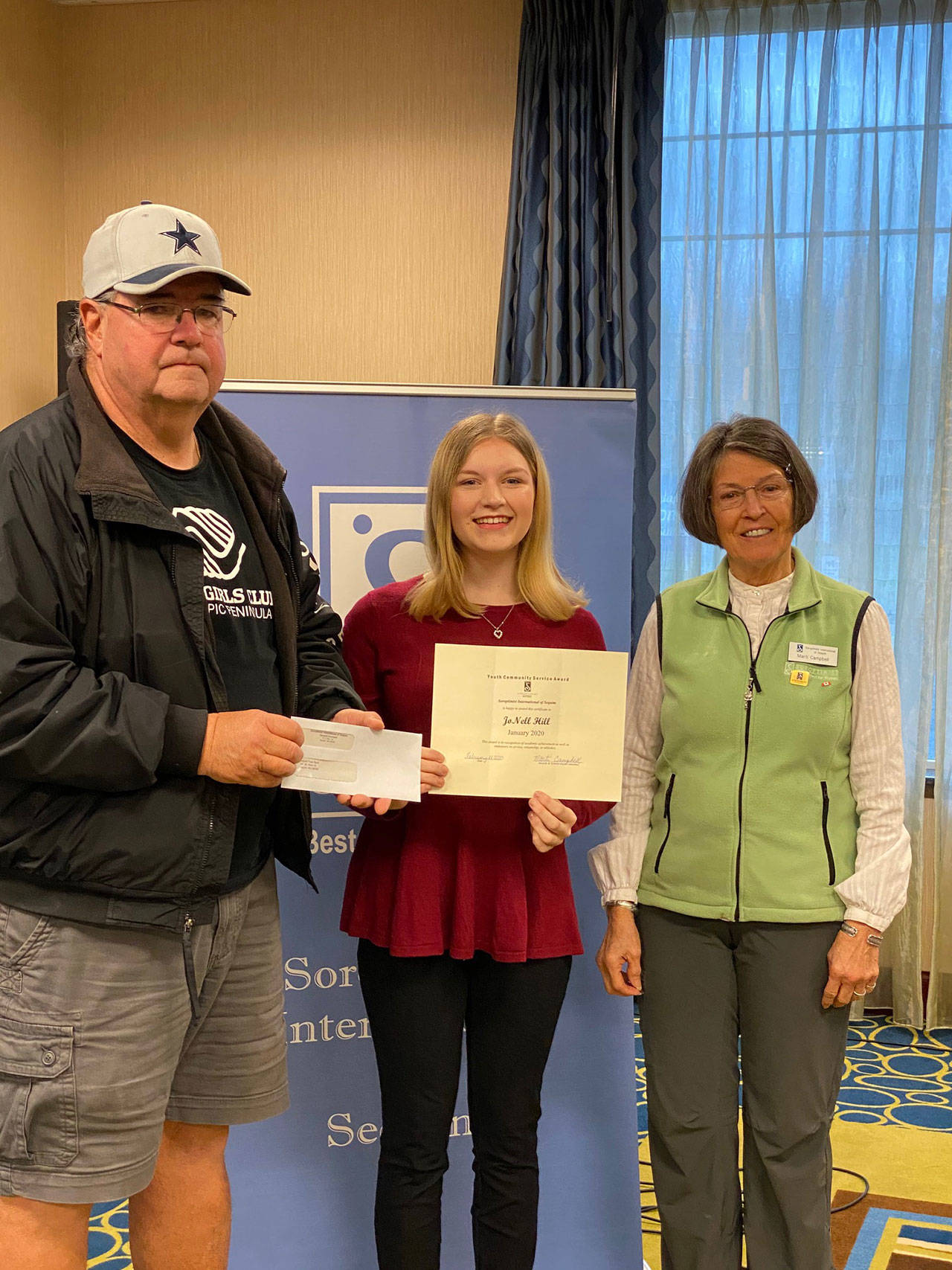 Pictured, from left, are Stephen Rosales and Jonell Hill receiving the Soroptimist International of Sequim’a Youth Community Award on behalf of the food bank, presented by Marti Campbell, a member of Soroptimist International of Sequim. Submitted photo