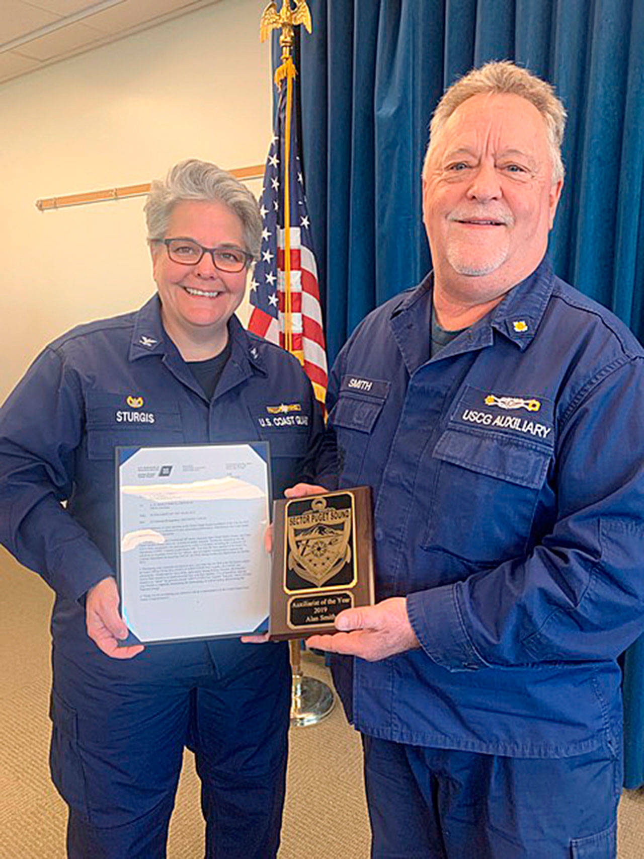 Capt. Linda A. Sturgis, U.S. Coast Guard Sector Puget Sound commander, helps honor Sequim’s Alan Smith, Sector Puget Sound Auxiliarist of the Year for 2019. Photo by Kent Brown/USCG Auxiliary