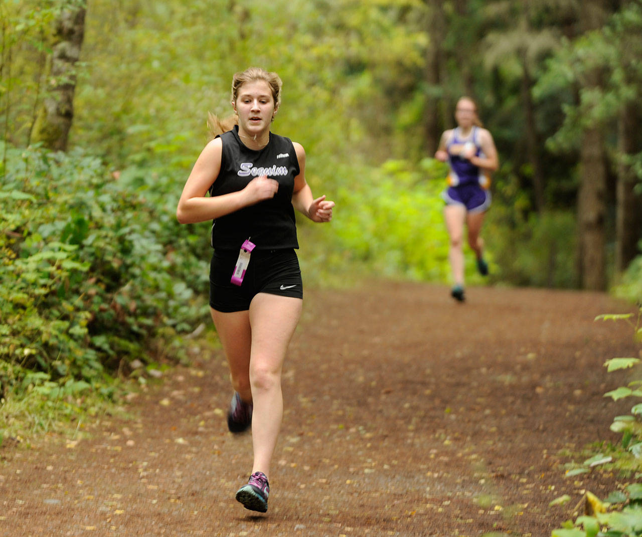 Sequim High senior Emily Silva, pictured here racing at Robin Hill County Park during an Olympic League meet in 2019, recently signed a letter of intent to compete in cross country and track at Olympic College. Sequim Gazette file photo by Michael Dashiell