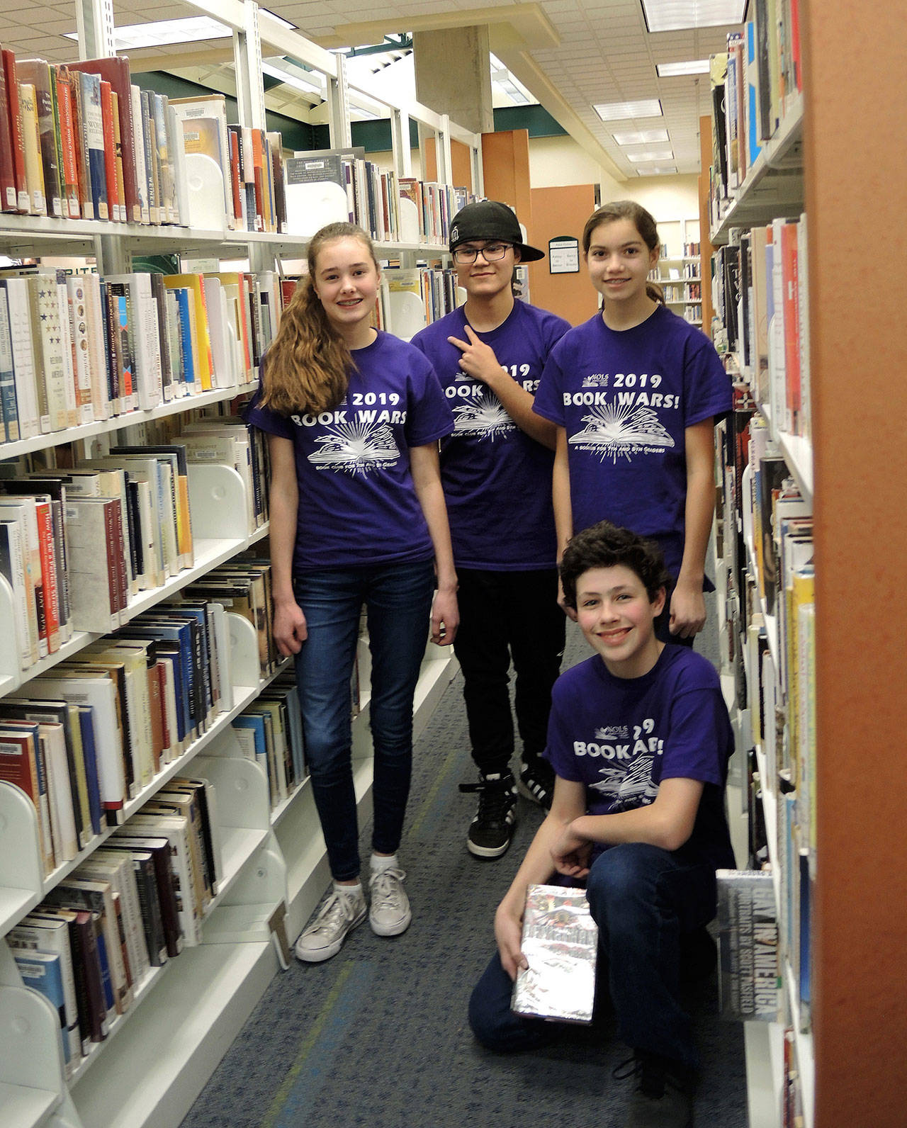 The 2019 Book Wars! winners from Sequim Middle School’s Phoenix Riders team include, from left, Anastasia Updike, Calem Klinger, Kari Olson and (kneeling) Ayden Humphries. Photo courtesy of North Olympic Library System