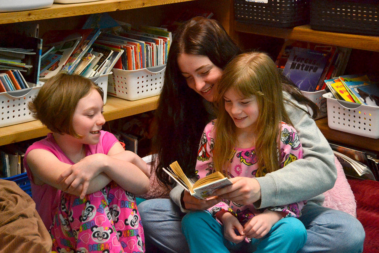 Abigail Schroeder shares a corner with Jody Hamilton and Piper Jackson to read together during Read Across America Day in Rachel Oden’s third grade class. Sequim Gazette photos by Matthew Nash