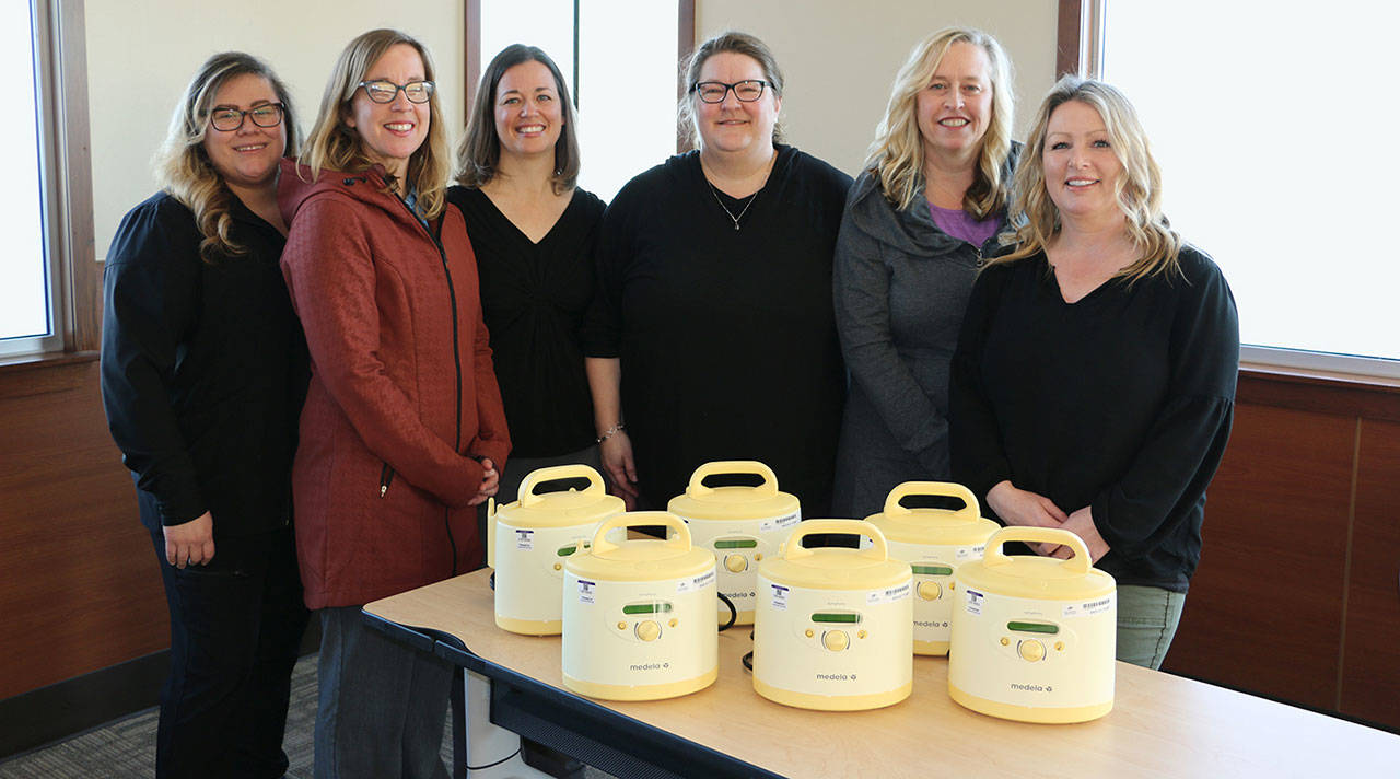 Pictured with new breast pumps purchased with a grant from the Benjamin N. Phillips Memorial Fund are, from left: Samantha Lusk, obstetrics and new family services health unit coordinator; Wendy Schroeder, New Family Services Lactation Consultants Wendy Schroeder, Heidi Byers, Kelly Watkins and Stephanie Steinman, and Chris Johnson, director of obstetrics and new family services. Photo courtesy of Olympic Medical Center