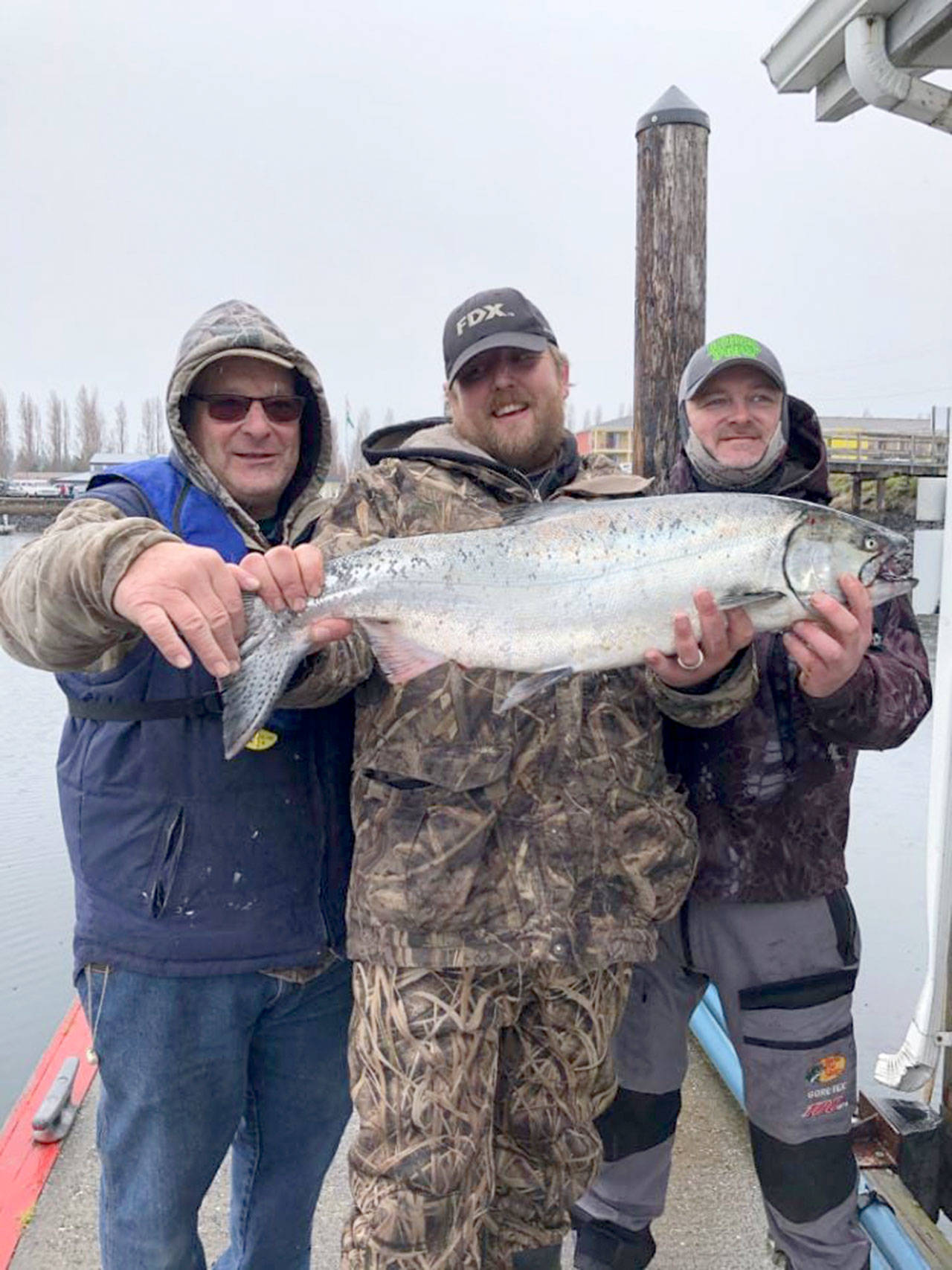 Bellingham’s Brandon Leeper, center, caught this 15.7-pound hatchery chinook off Port Townsend on March 13 and was atop leaderboard after the first day of the Olympic Peninsula Salmon Derby. Leeper’s catch went on to win the event. Photo courtesy of Olympic Peninsula Salmon Derby