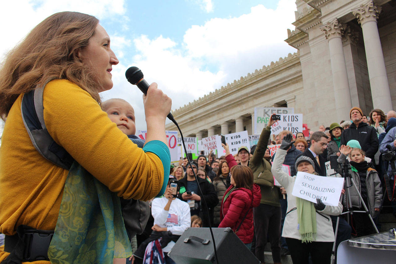 Dr. Sarah Bartel leads the crowd in prayer at a March 10 protest of Senate Bill 5395. Photo by Cameron Sheppard/WNPA News Service