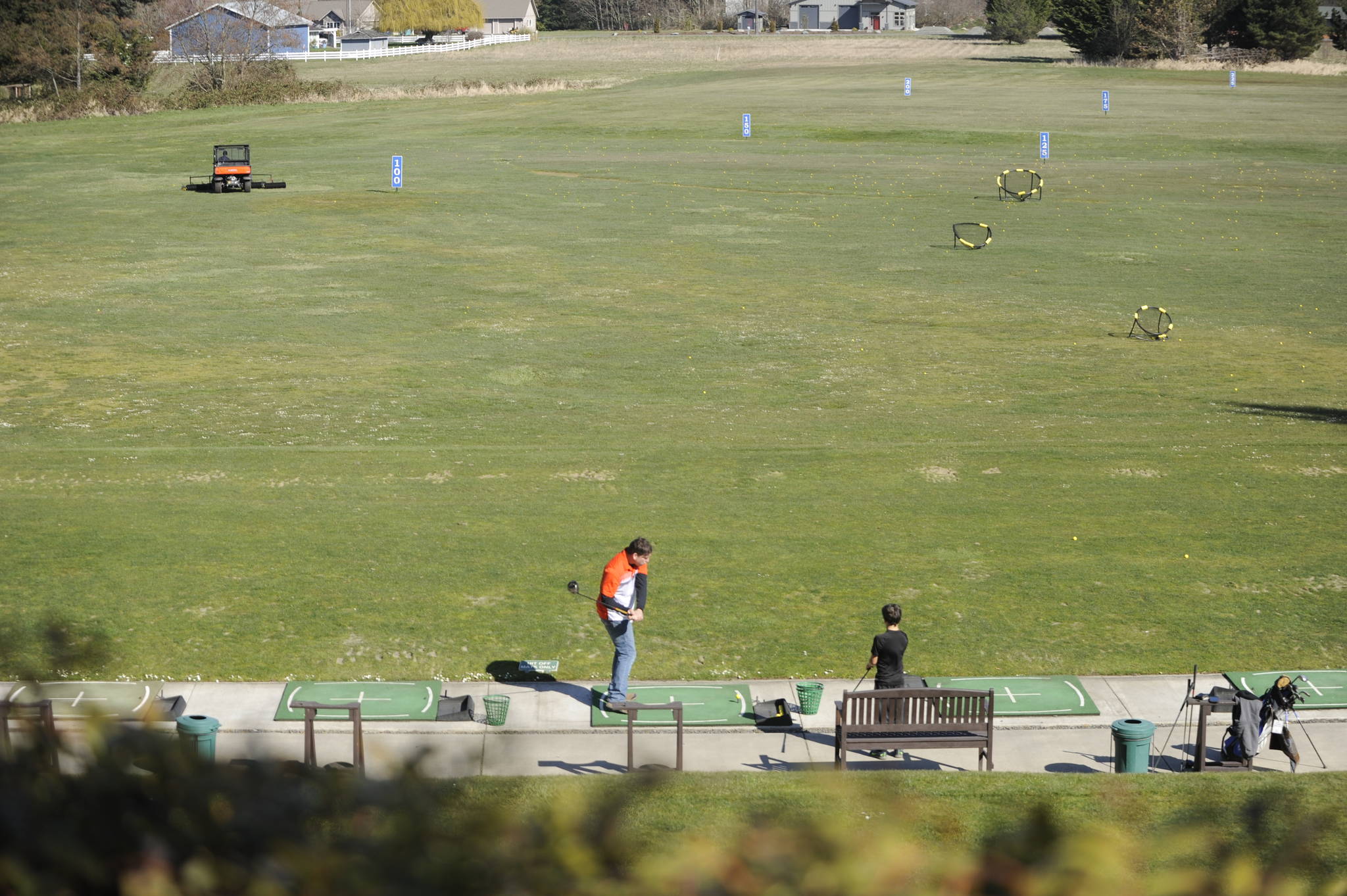 A few golfers get some swings in at The Cedars at Dungeness golf course’s driving range last week. The course closed this week in light of Gov. Jay Inslee’s “stay at home” order. Sequim Gazette file photo by Michael Dashiell