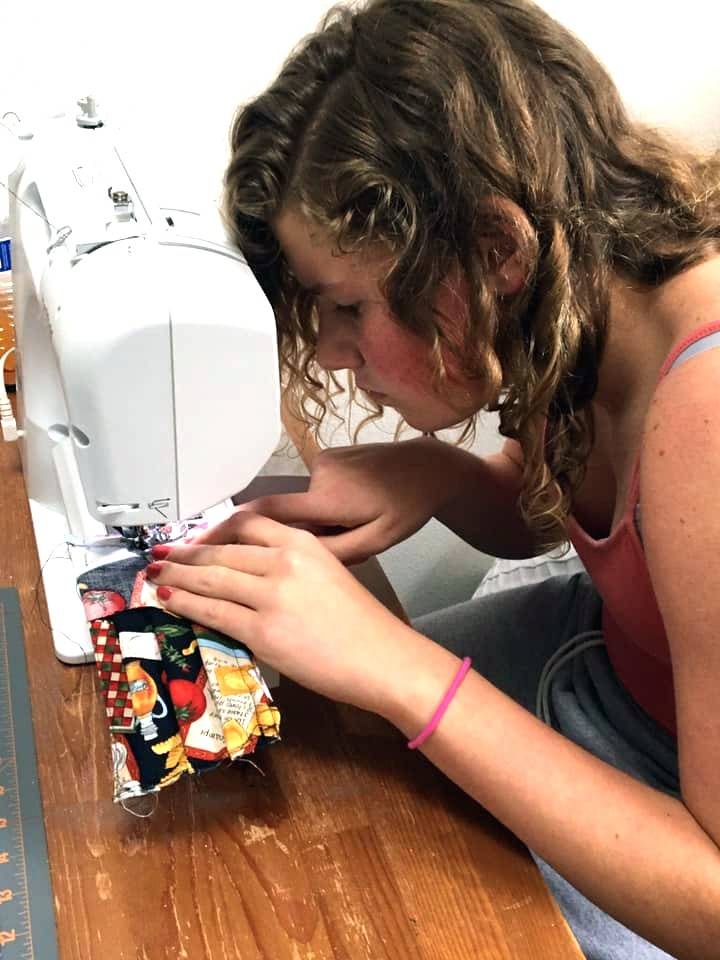 Paige Krzyworz makes face masks with her mom Heidi as a new project they started together. Heidi said she was going to donate fabric late last year but Paige said they might need it for something important. “She was right,” Heidi said. Photo courtesy of Heidi Sellers-Krzyworz
