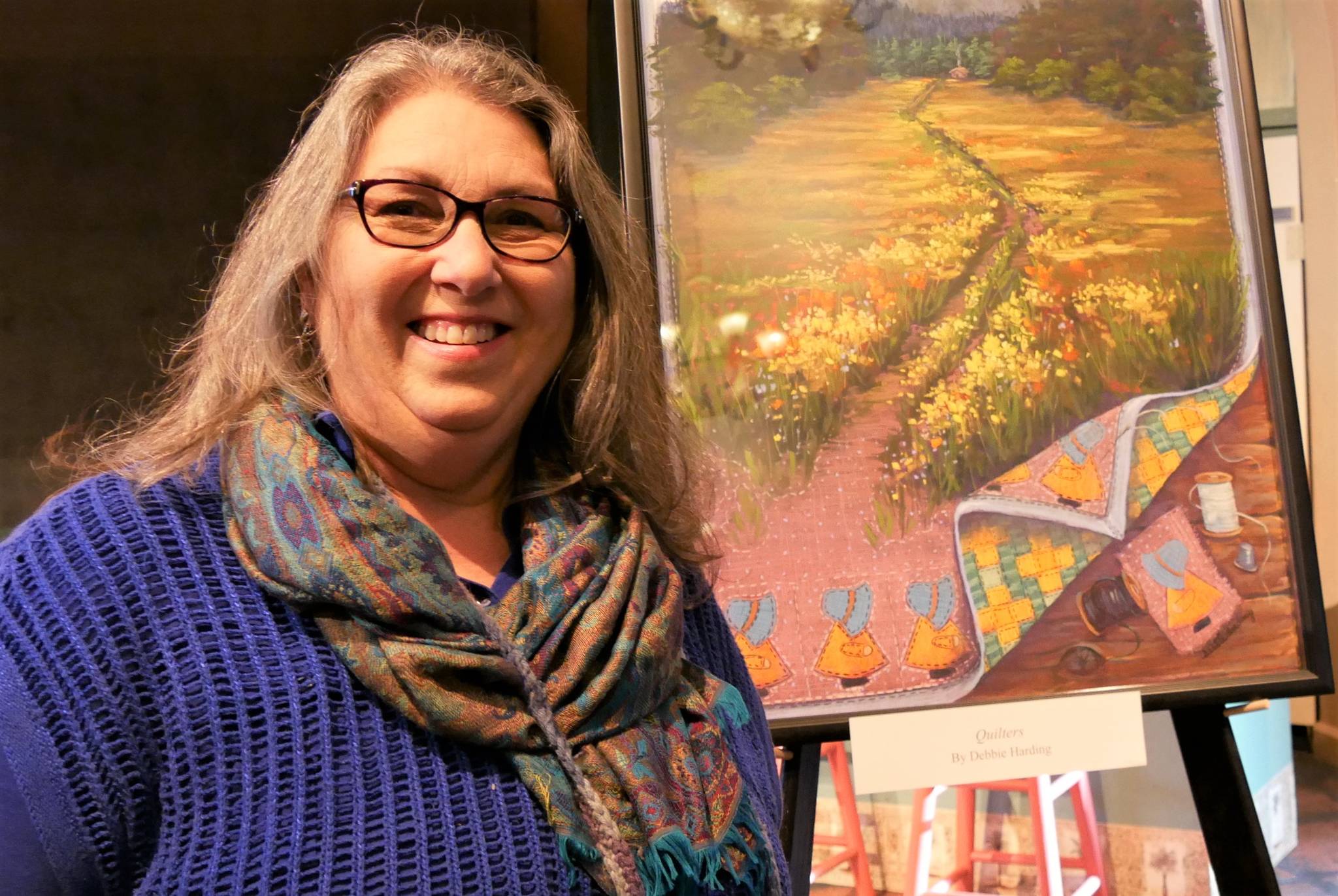 Local artist Debbie Harding displaying her artwork in a Gathering Hall event for Olympic Theatre Arts’ recent production of “Quilters.” Photo courtesy of Olympic Theatre Arts
