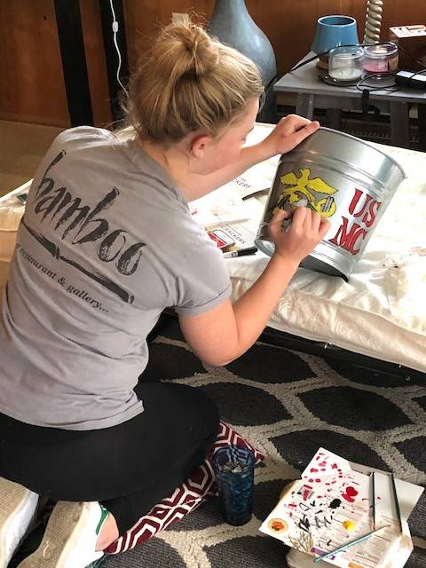 Ashleigh Cate decorates a bucket for goodies she plans to give to graduate-to-be Connor Forderer. She and her family adopted Connor as part of the Sequim High School Adopt a Senior 2020 Facebook program because she plans to enlist in the US Army as as a medic, and Connor plans to enlist in the US Marines. Photo courtesy of Chad Cate