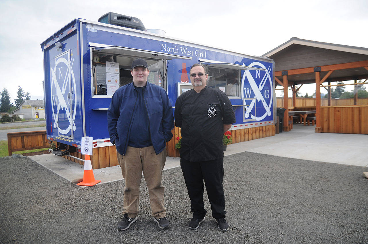 North West Grill owner Shane Dennis, right, and David Burnham stand outside the food truck last week. Business has been solid since opening about three weeks ago, Dennis said. Sequim Gazette photo by Michael Dashiell