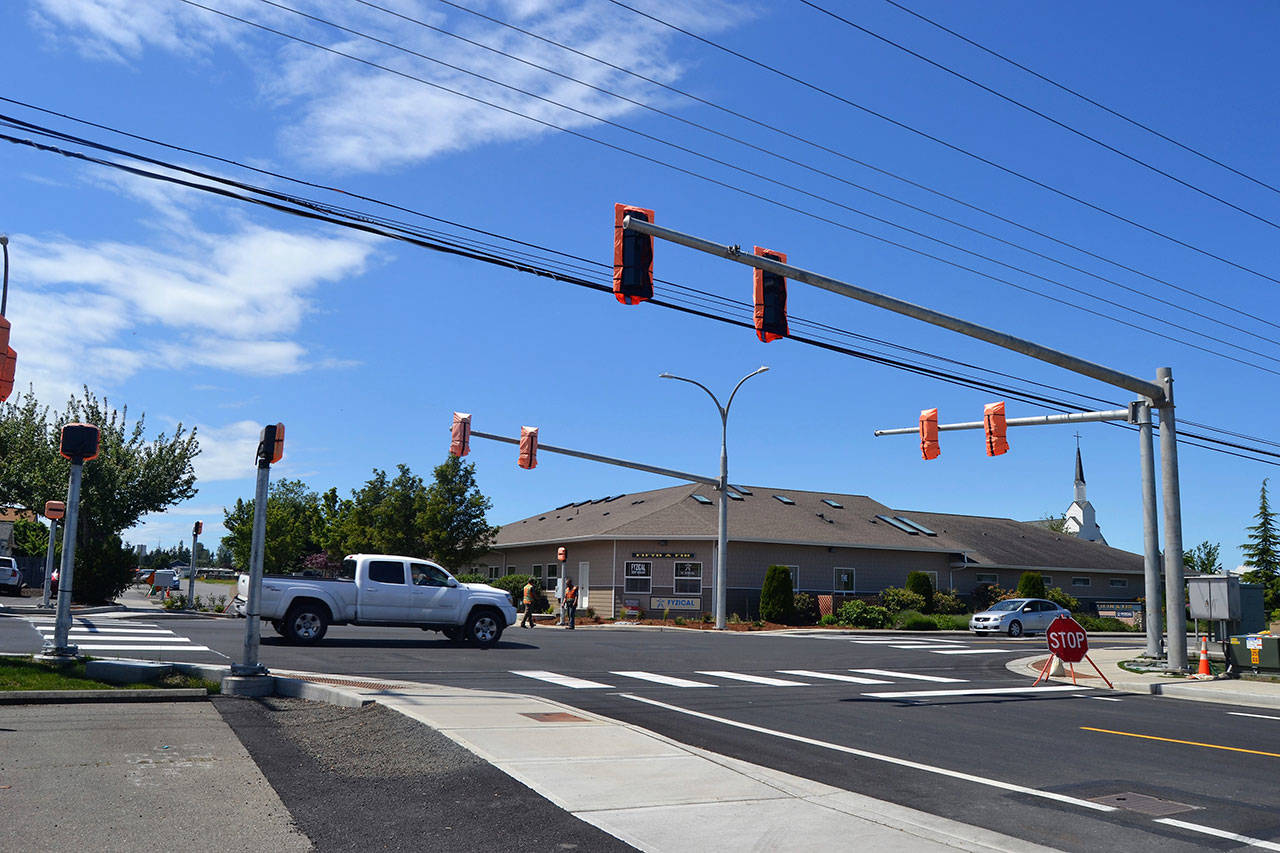 Crewmen with Olympic Electric continue work on new traffic lights at the intersection of North Fifth Avenue and West Fir Street this week to have the lights working by June 16. Sequim Gazette photo by Matthew Nash