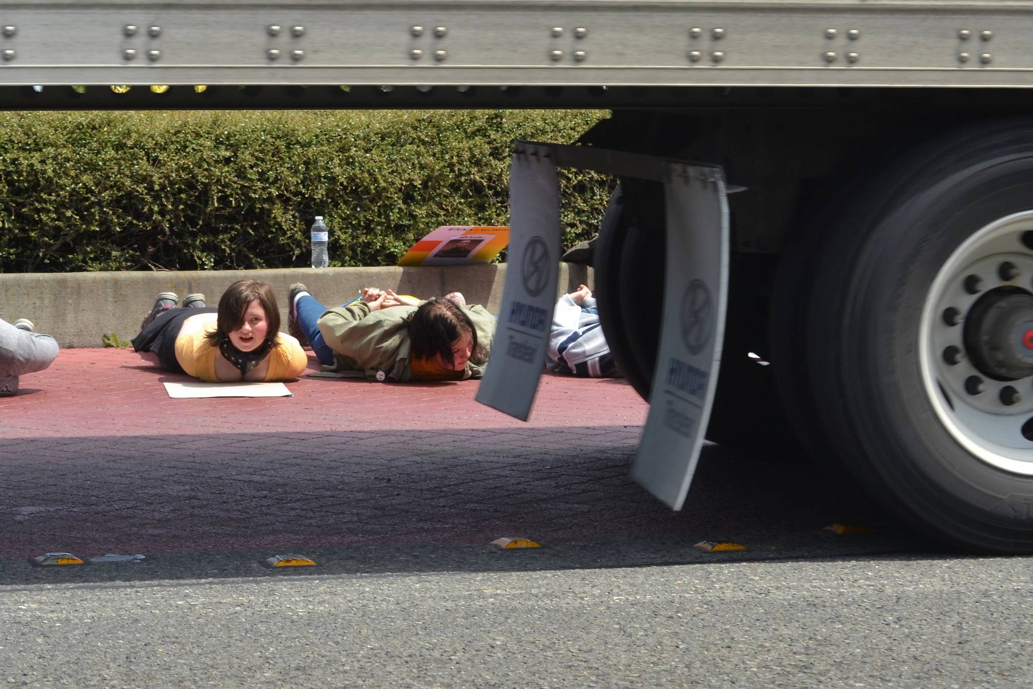 Lyndsai Seator of Sequim watches as a semi-truck circles the River Road roundabout on June 4 while she and other demonstrators lay down in support of the Black Lives Matter movement and to recognize the death of George Floyd. Sequim Gazette photo by Matthew Nash
