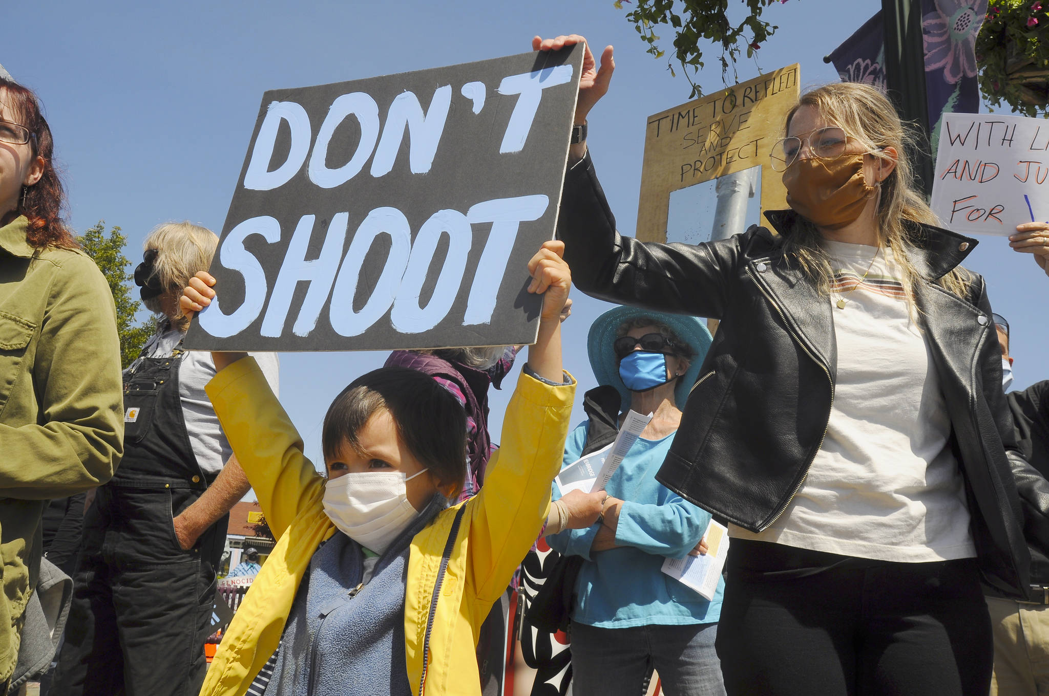 S. Beckett Thomas, 5, holds a “Don’t shoot” sign with mom Courtney Thomas looking on. Courtney organized the protest, saying, “I’m scared for the world, for my son. This (protest) is the least I can do.” Sequim Gazette photo by Michael Dashiell
