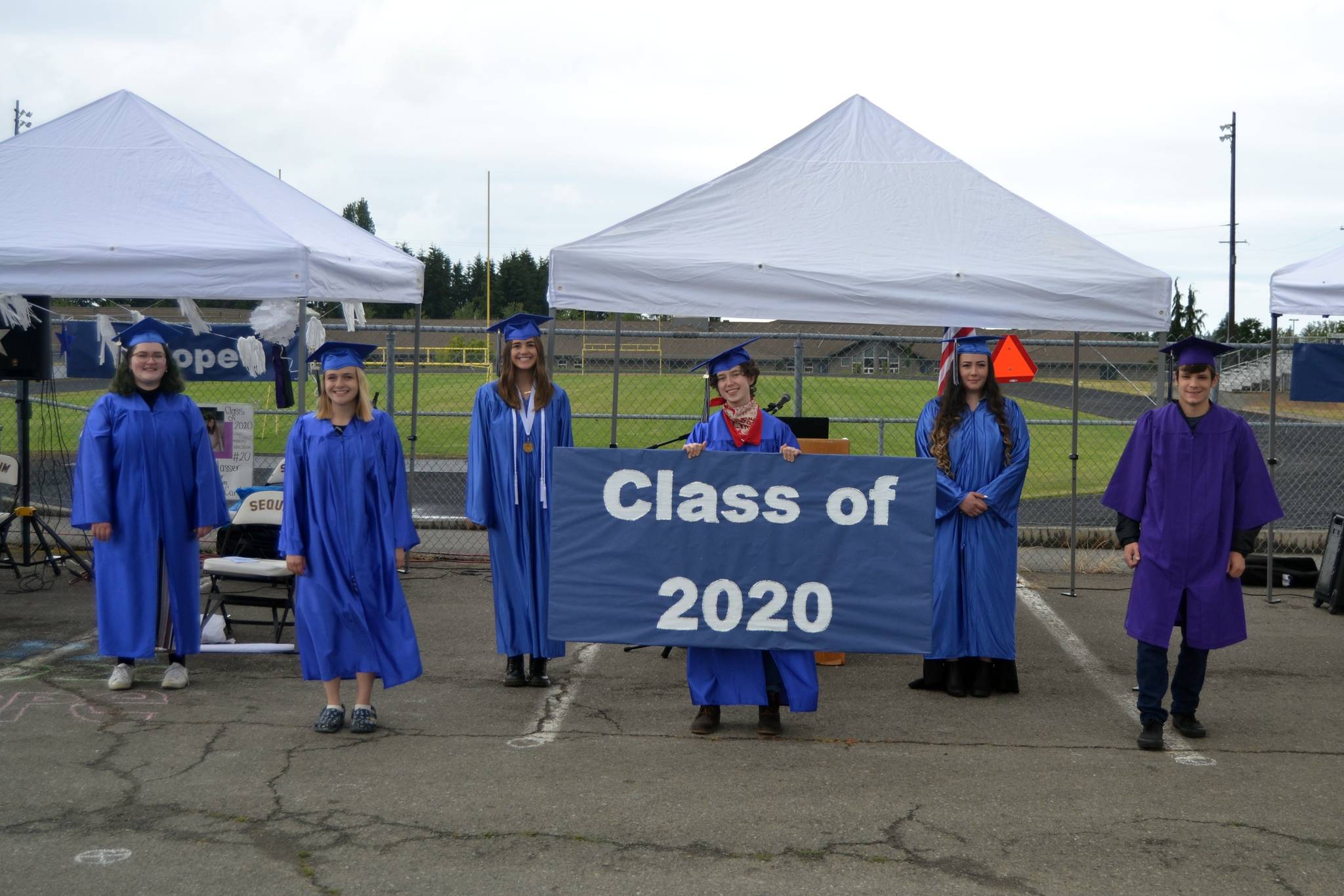 Olympic Peninsula Academy celebrated its high school graduates on June 12 with, from left, Lily Engeset, Emily Nielsen, Hope Glasser, Gianna Halo, Samantha White, and Silas Thomas participating in a special outdoor ceremony at the Sequim School District stadium’s parking lot. Sequim Gazette photos by Matthew Nash