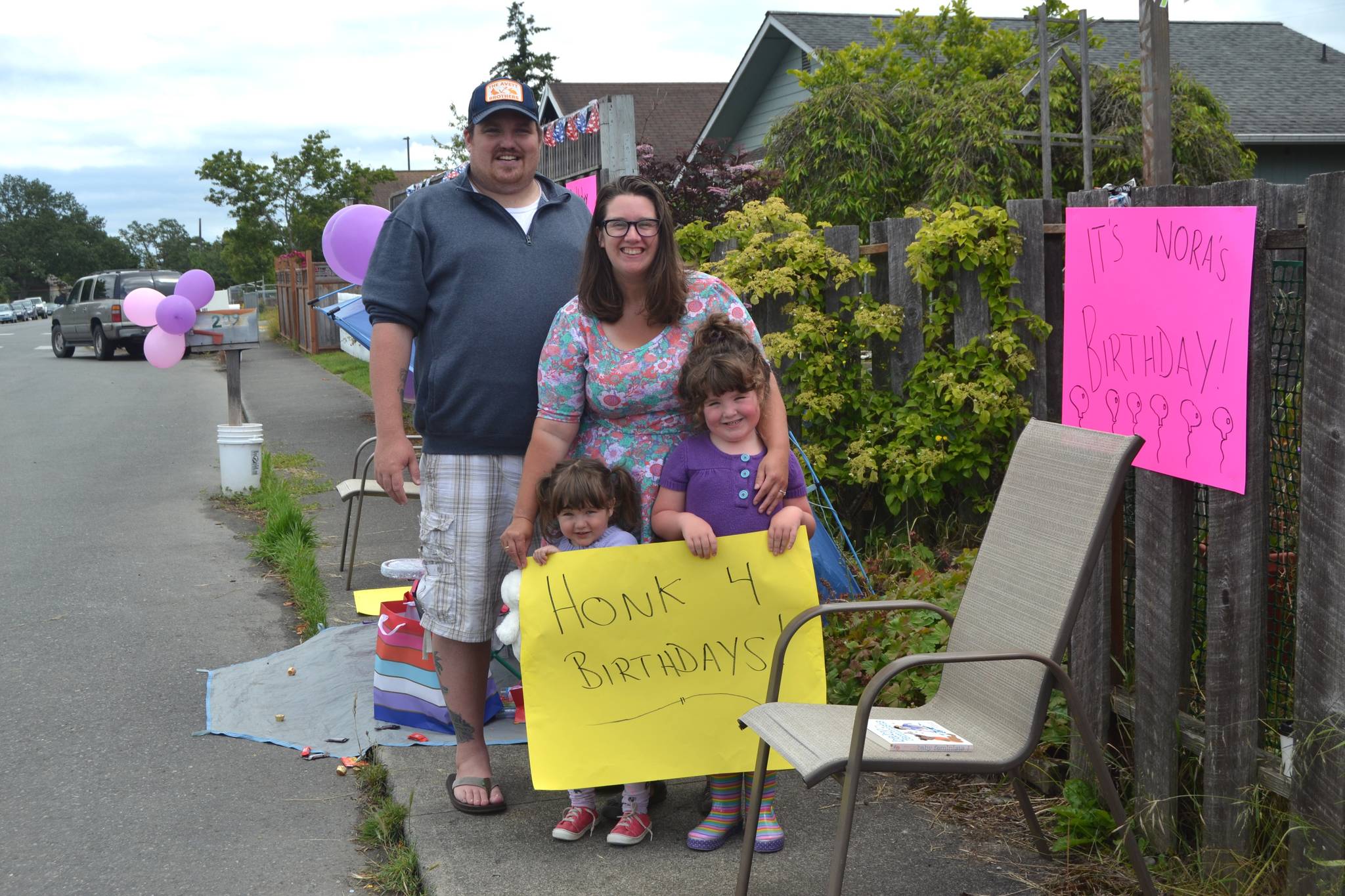 On June 20, the Hannam family sat outside their downtown Sequim home waving to cars in honor of Nora’s third birthday, See story on Page 3. Sequim Gazette photo by Matthew Nash