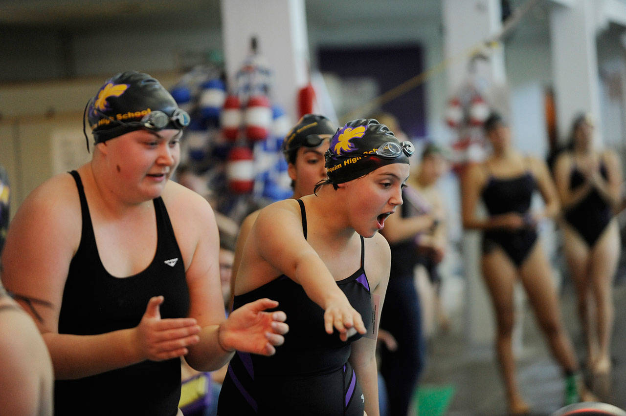Sequim High girls swimmers cheer on their teammates in a September 2019 Olympic League meet. WIAA officials have shifted girls swimming from the fall season to early spring, joining football, girls soccer and volleyball. Sequim Gazette file photo by Michael Dashiell