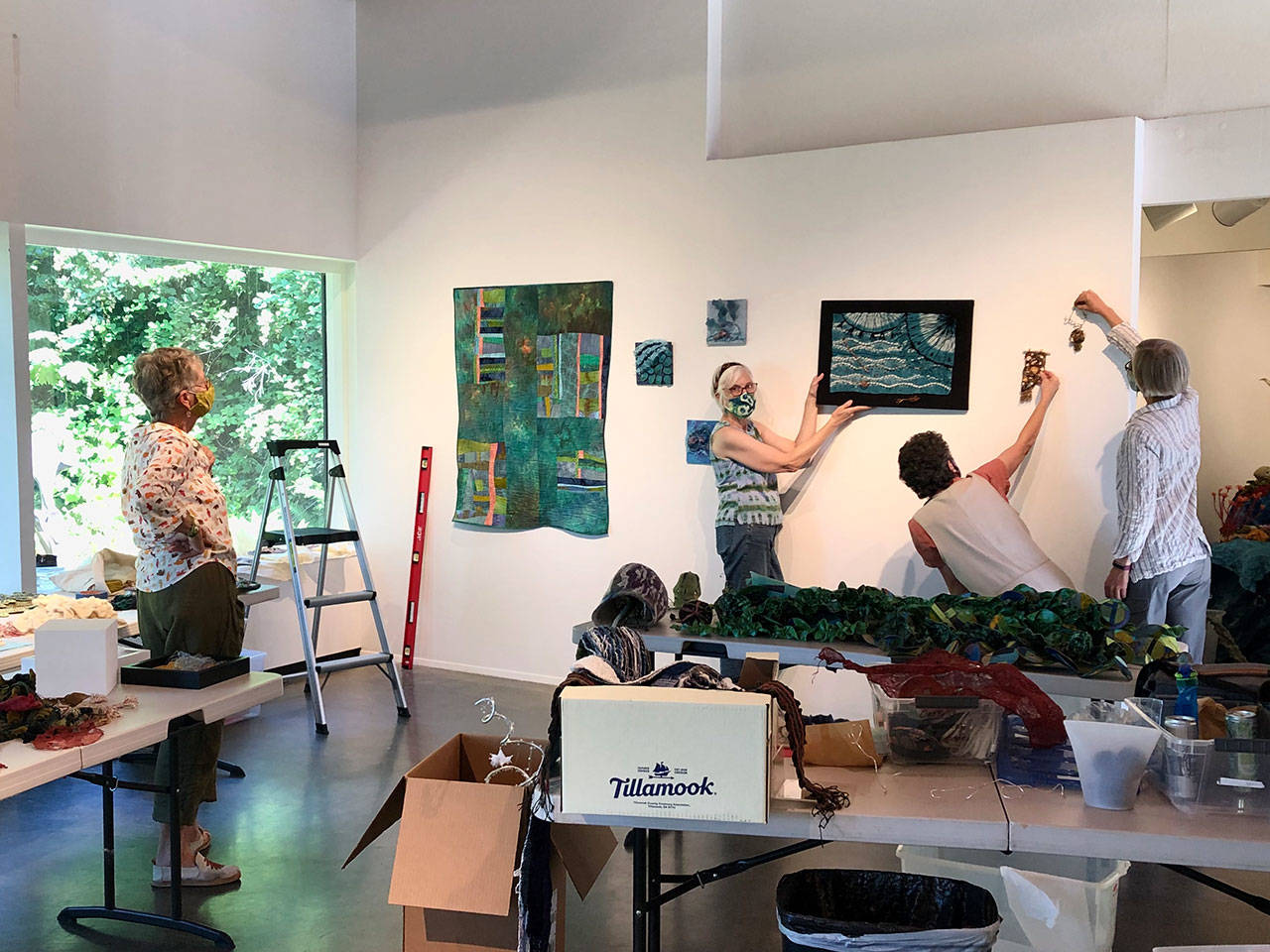 The four artists of Tangled Fibers install their “Undersea Garden” exhibit. Pictured are, from left, Pat Herkal, Barbara Ramsey, Jean-Marie Tarasci and Cathie Wier. Photo courtesy of Port Angeles Fine Arts Center