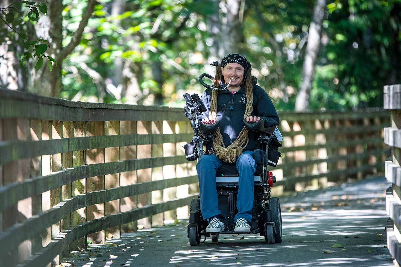 Ian Mackay, executive director of Ian’s Ride, rides his powered wheelchair on the Olympic Discovery Trail near Port Angeles last month. Photo by Jesse Major/Ian’s Ride