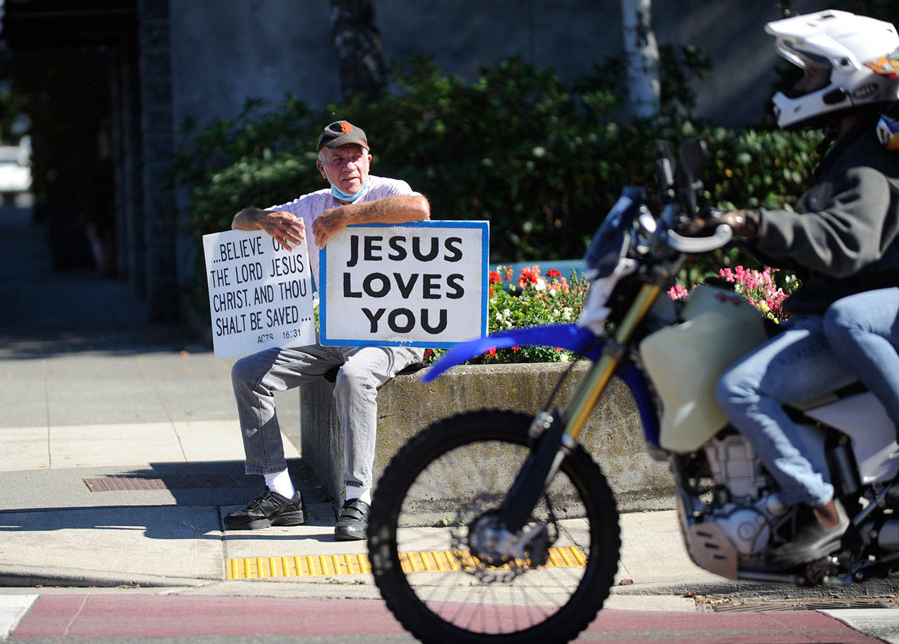 Since late July, Jim Nightingale has held his signs on the southeast corner of Sequim Avenue and Washington Street for about six hours a day. “There’s nothing greater than holding up the name of Jesus," he said. Sequim Gazette photo by Michael Dashiell