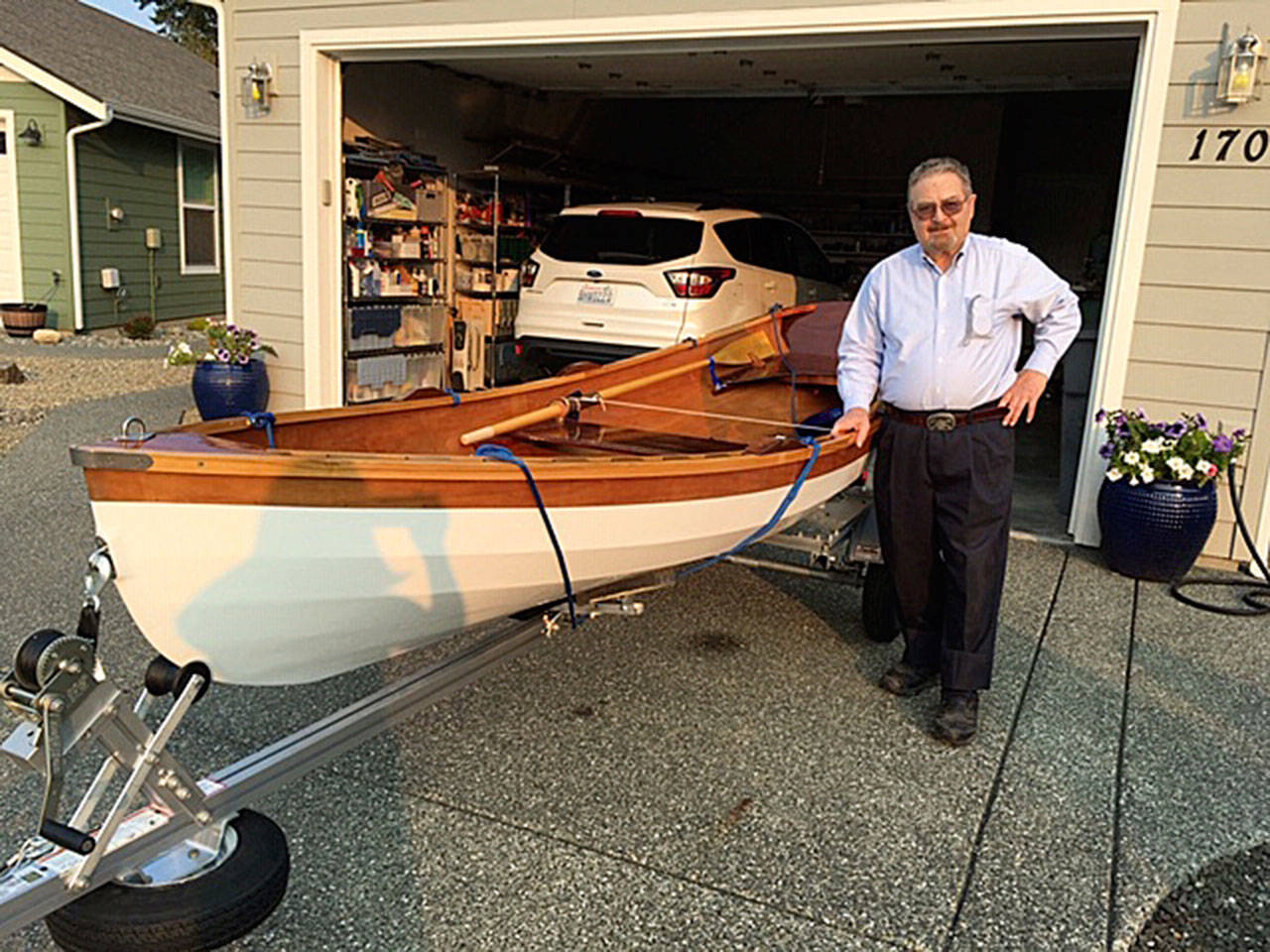 David Hough of Sequim stands by his wherry he built from a kit during the past few months. The “Planet X” saw its maiden voyage in Sequim Bay in late September. Submitted photo