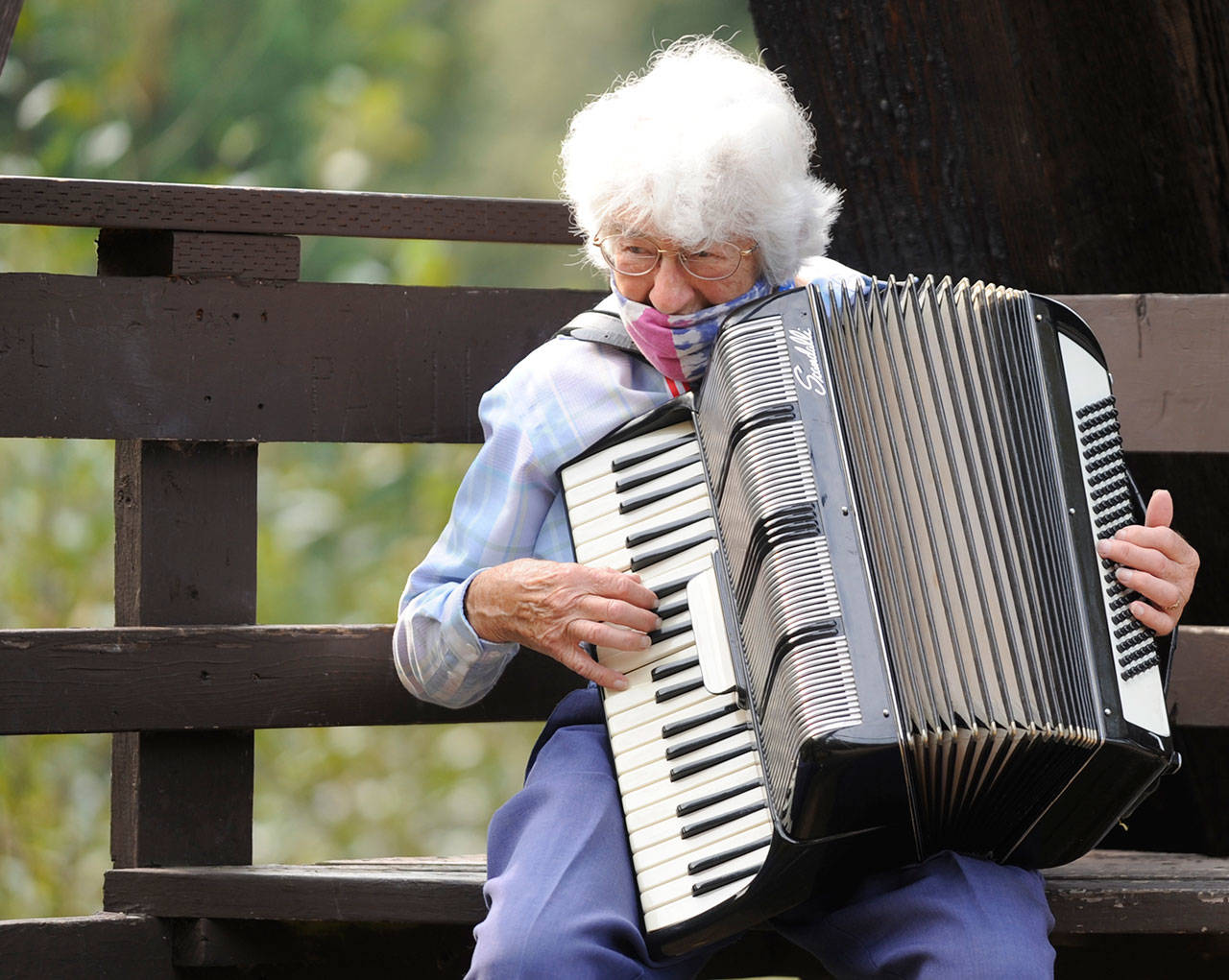 Helen Bucher, a lifelong Sequim resident and former Irrigation Festival Grand Pioneer (2015), celebrates her 90th birthday with some accordion playing at the Railroad Bridge Park on Oct. 1. Sequim Gazette photo by Michael Dashiell