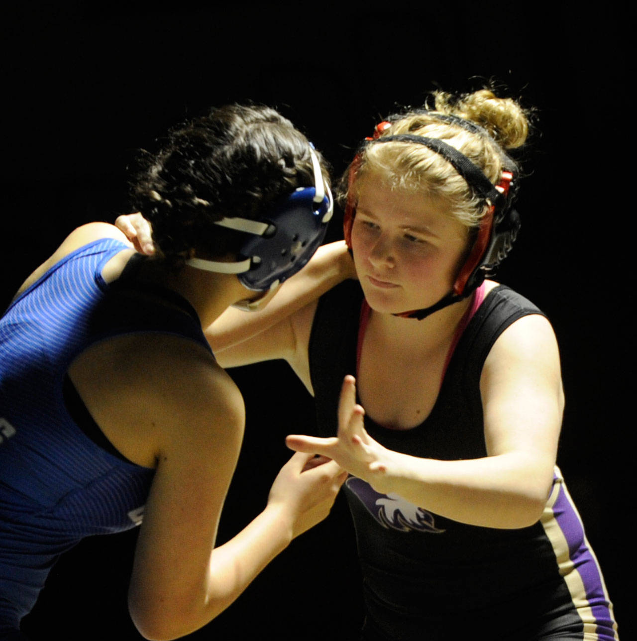 Sequim’s Petra Bernsten, right, takes on Olympic’s Alessia Arpetti in an exhibition match in January. State officials have determined that high school wrestling and basketball are considered high-risk sports, so competition may begin in regions with low-risk transmission rates this December. Sequim Gazette file photo by Michael Dashiell