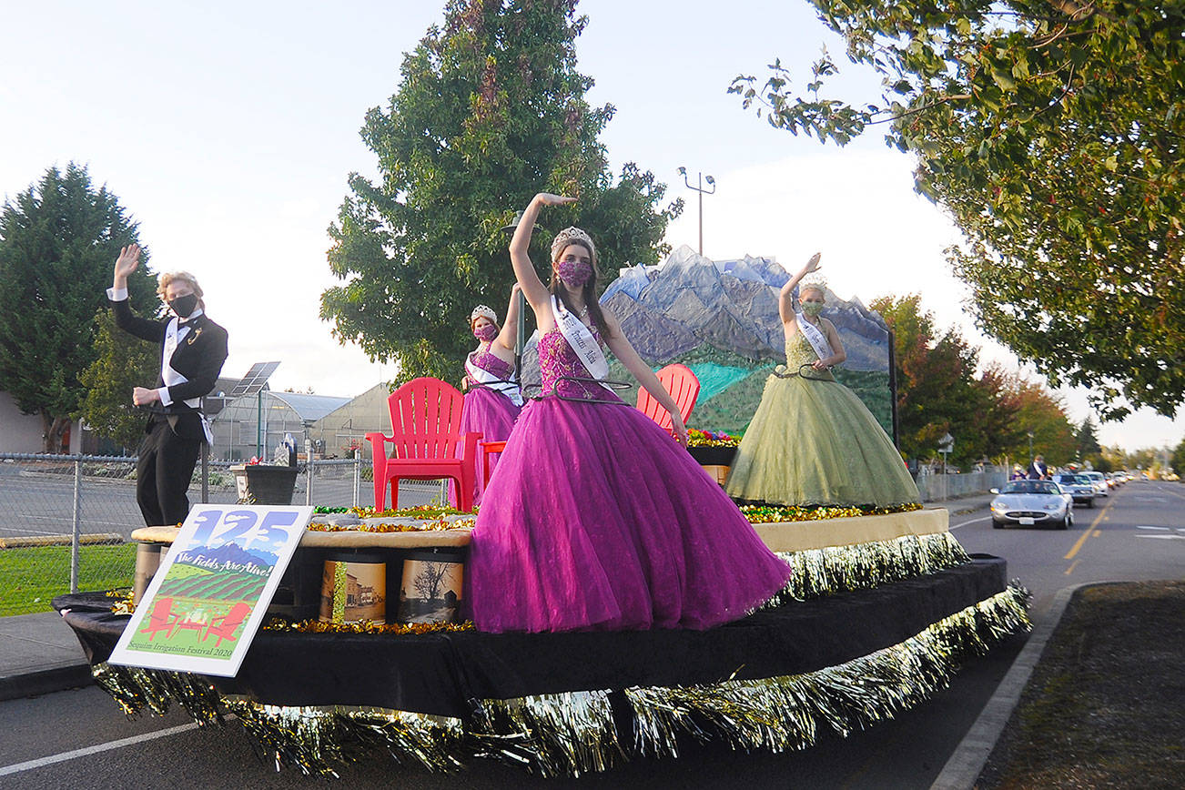 Royalty (from left) prince Logan Laxson, princess Brii Hingtgen, princess Alicia Pairadee and queen Lindsey Coffman wave to a virtual crowd on Sequim-Dungeness Way during the Sequim Irrigation Festival's makeshift Grand Parade on Saturday, Oct. 10. Sequim Gazette photo by Michael Dashiell